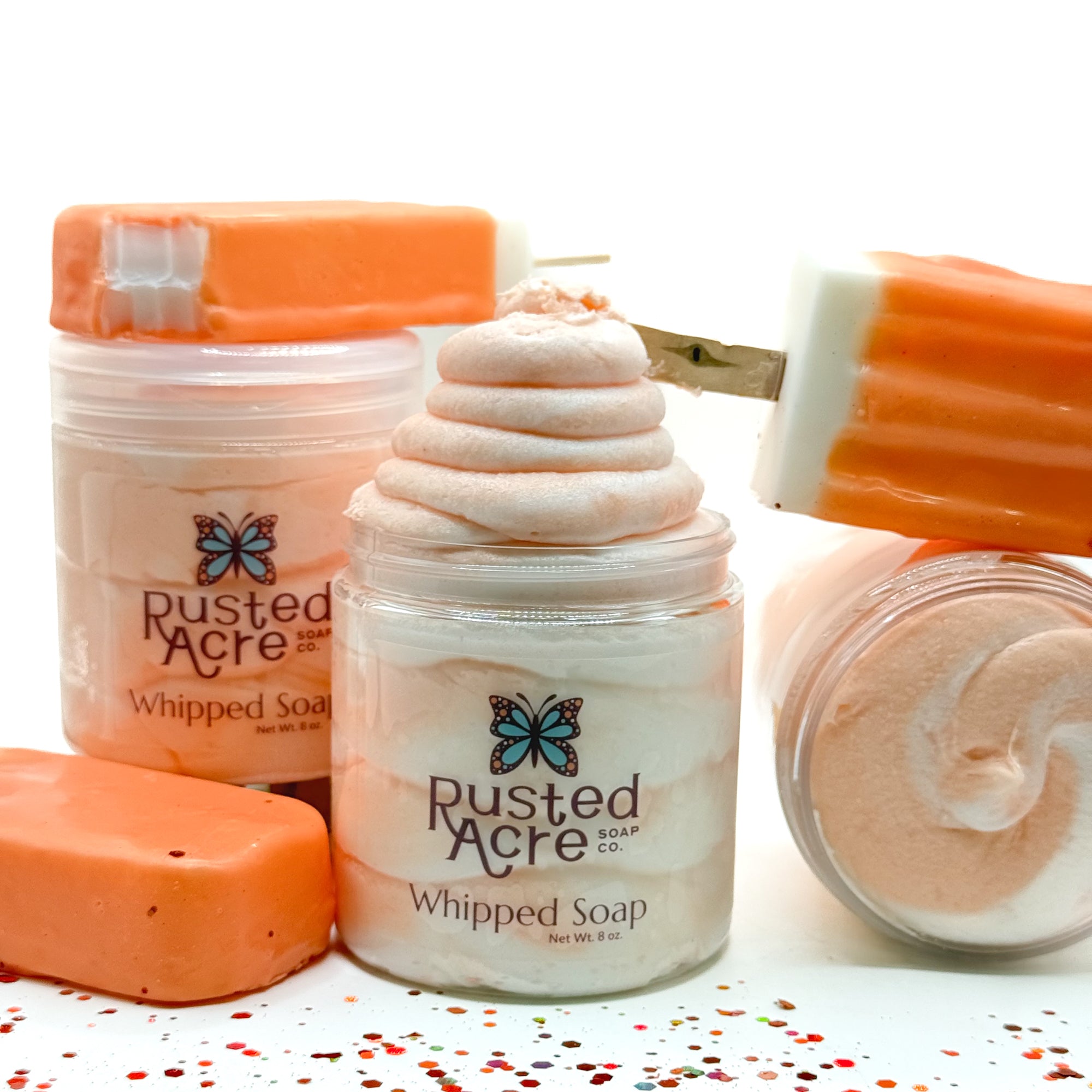 3 jars of orange and white swirl whipped soap with ice cream bars by Rusted Acre Soap Co.