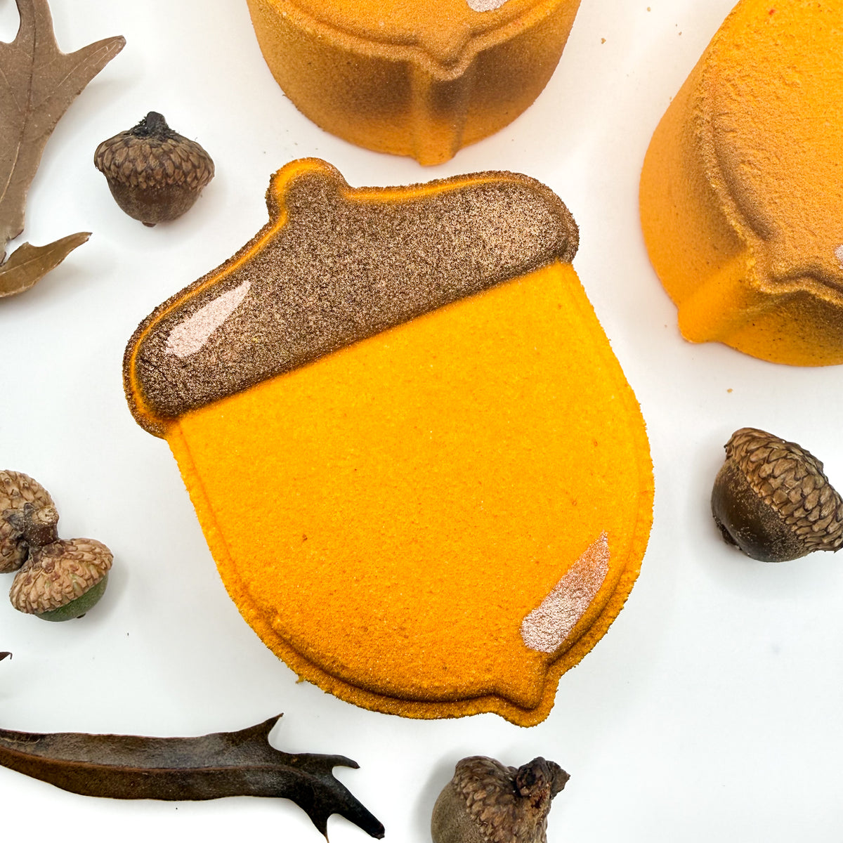 An acorn bath bomb. Autumn yellow, airbrushed lite tan, hand-painted brown top