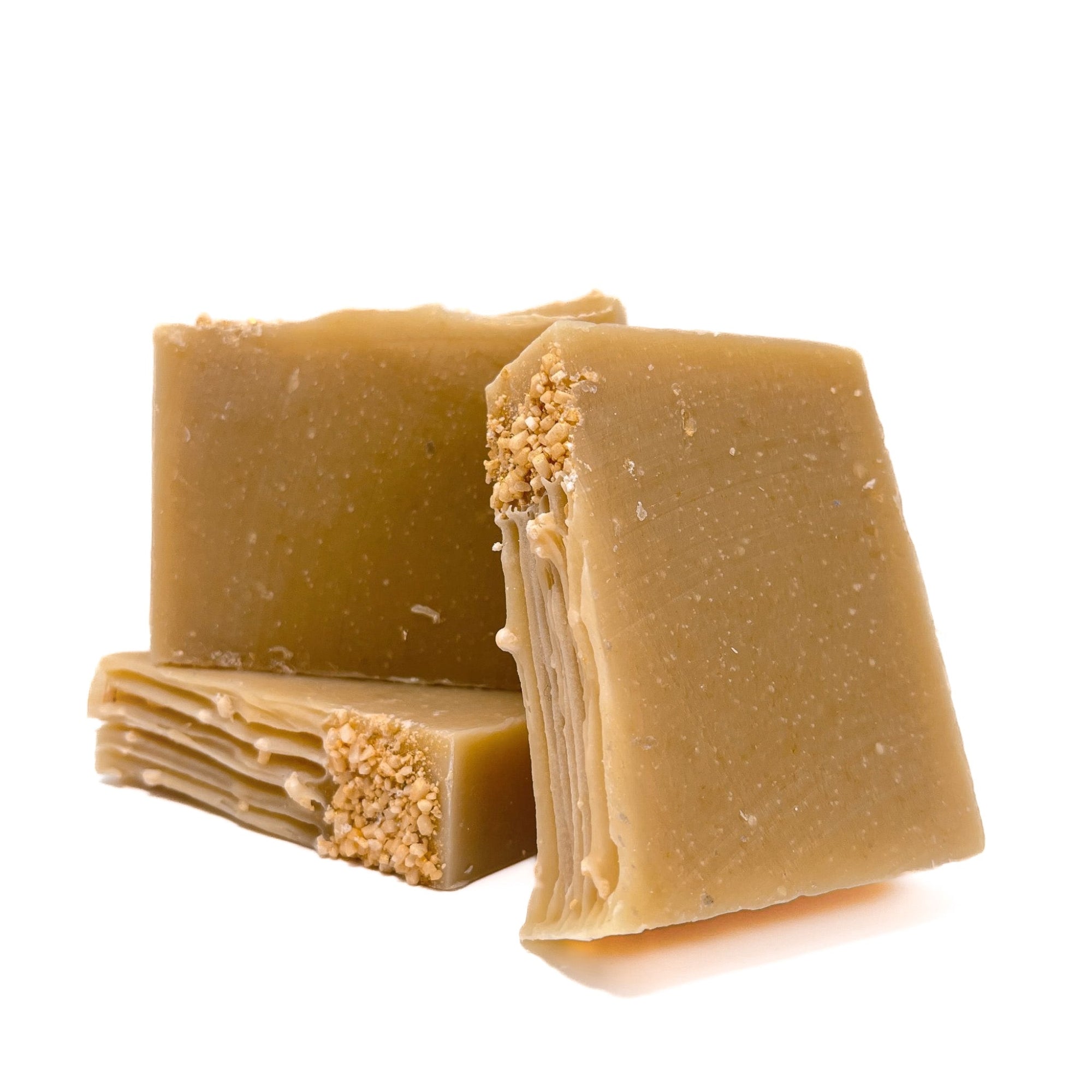 Three bars of bamboo colored handmade soap. One lying flat, two standing upright for texture.