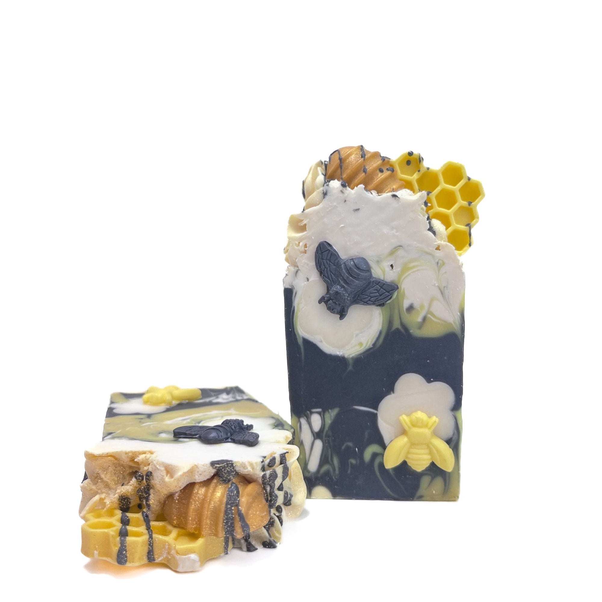 Two bars of Rusted Acre Soap Company's Bee Happy soap. One upright and one lying flat to show the top.