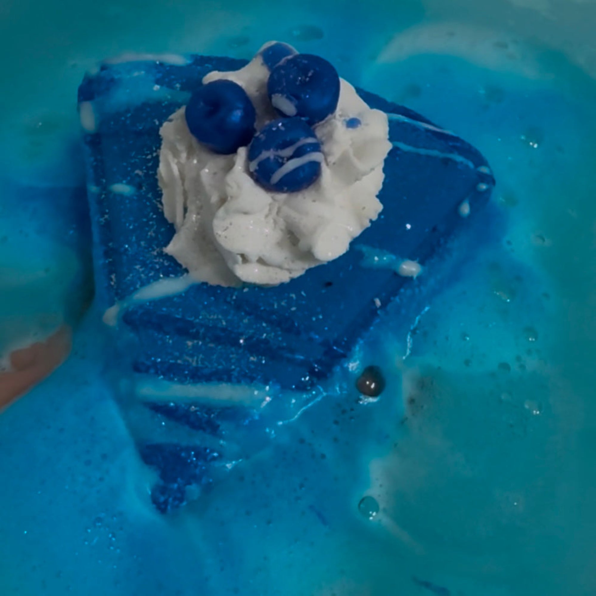 Rusted Acre Soap Companies Blue Berry Pie bath bomb putting on a color show.