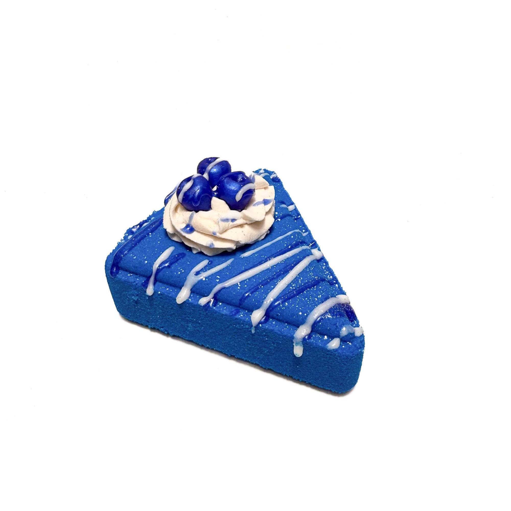 Blueberry colored pie slice bath bomb with white bubble bath frosting piped on top. Blueberry soap embedded in the frosting.