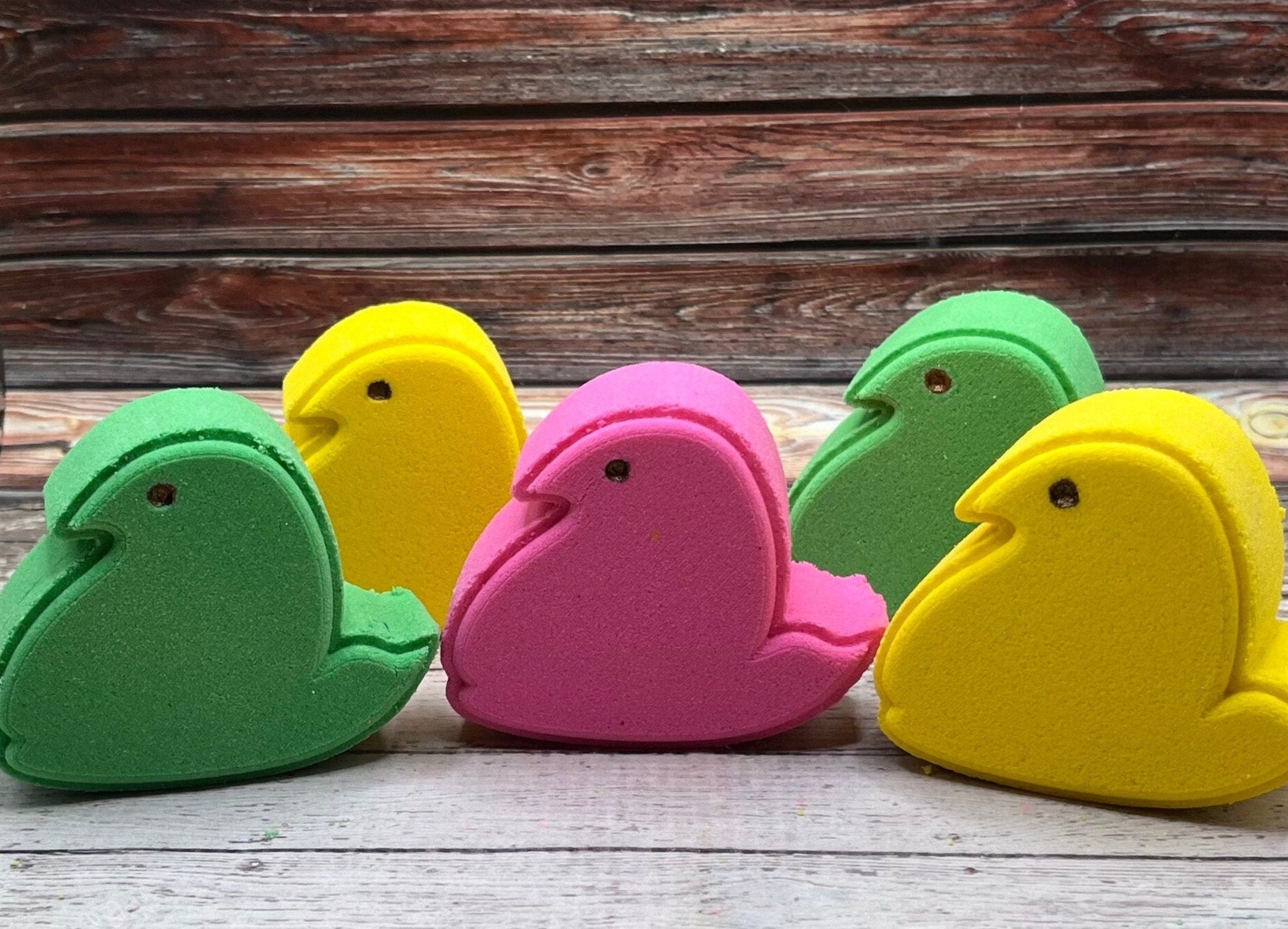 Five chick peep shaped bath bombs. Two yellow, Two green, one pink. Hand-painted eye.