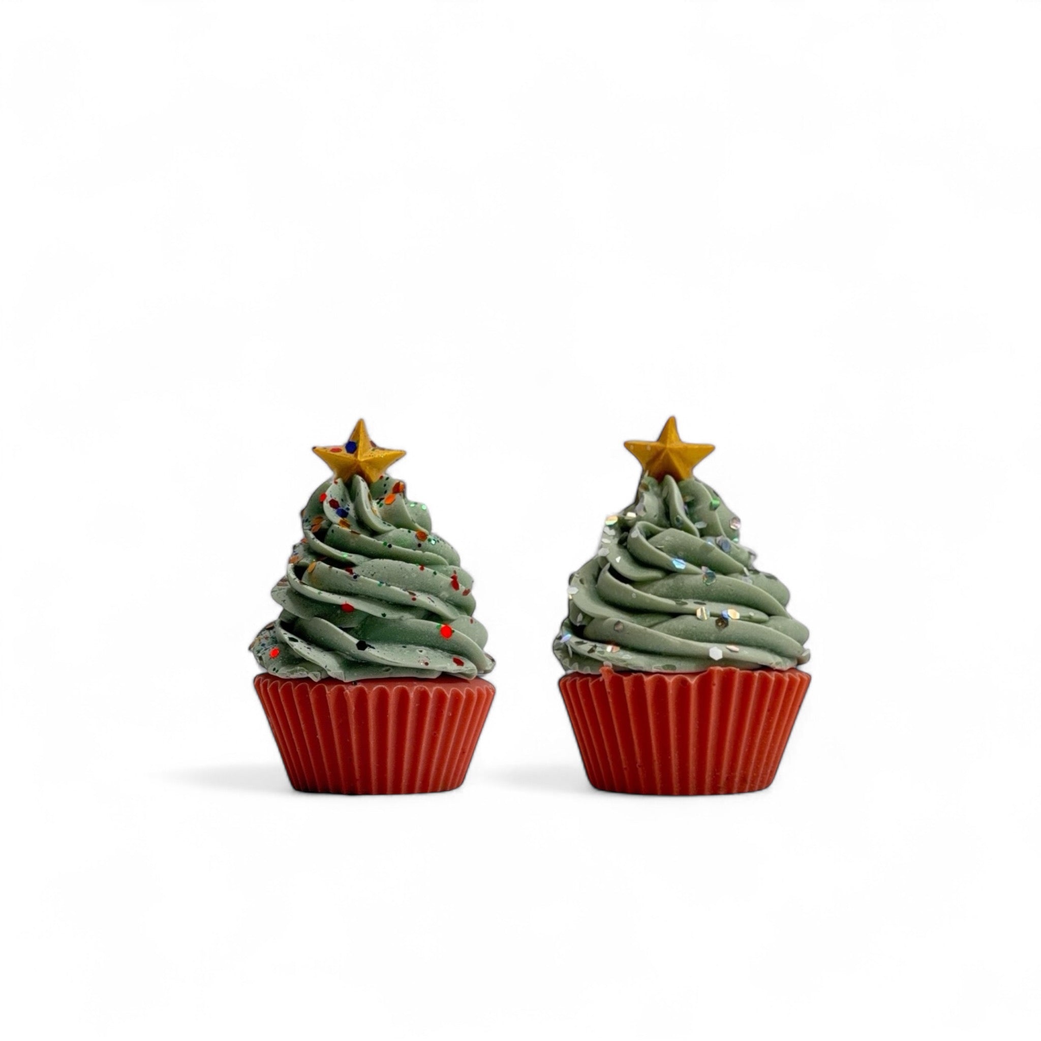 Two Christmas tree cupcake soaps handmade by Rusted Acre Soap Co. Red cake, green frosting topped with a gold soap star.