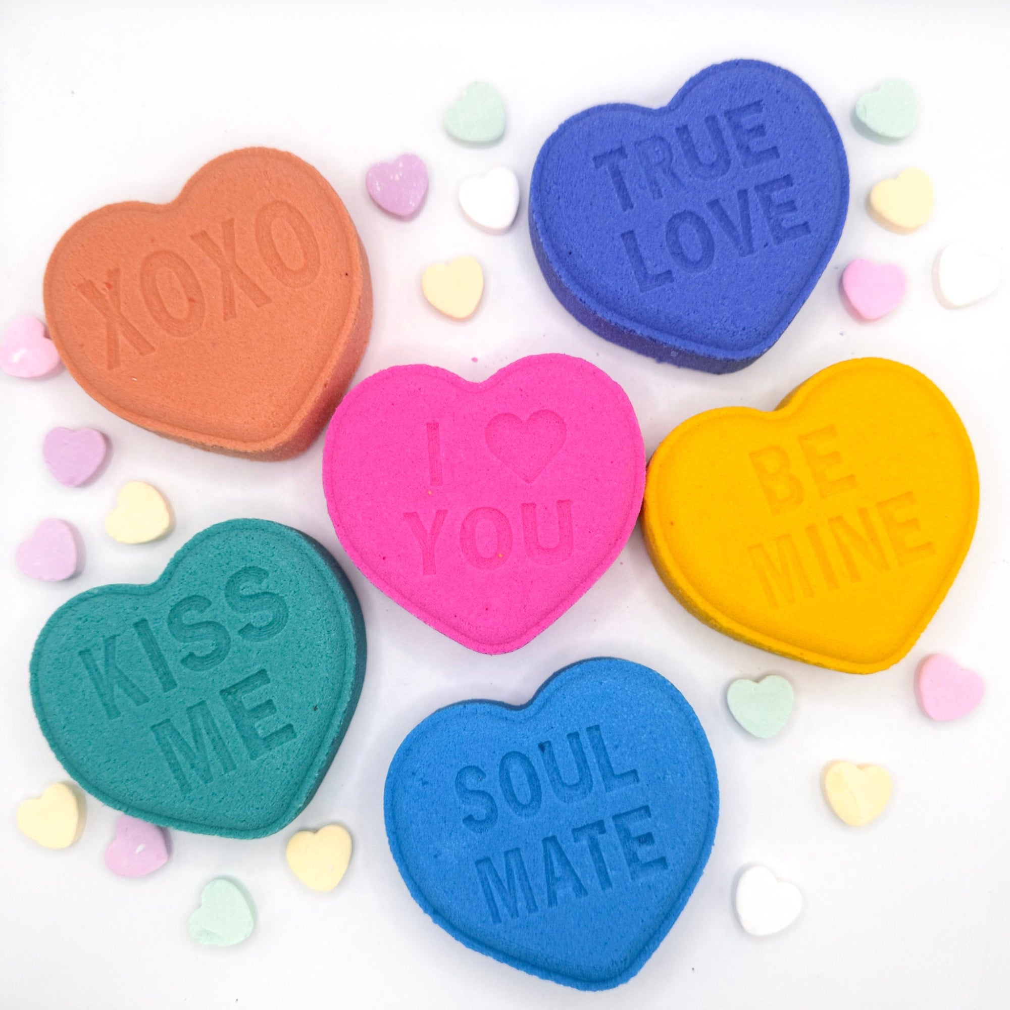 Six conversation heart shaped bath bombs. Colors are the following pastels blue, purple, yellow, green, pink, peach