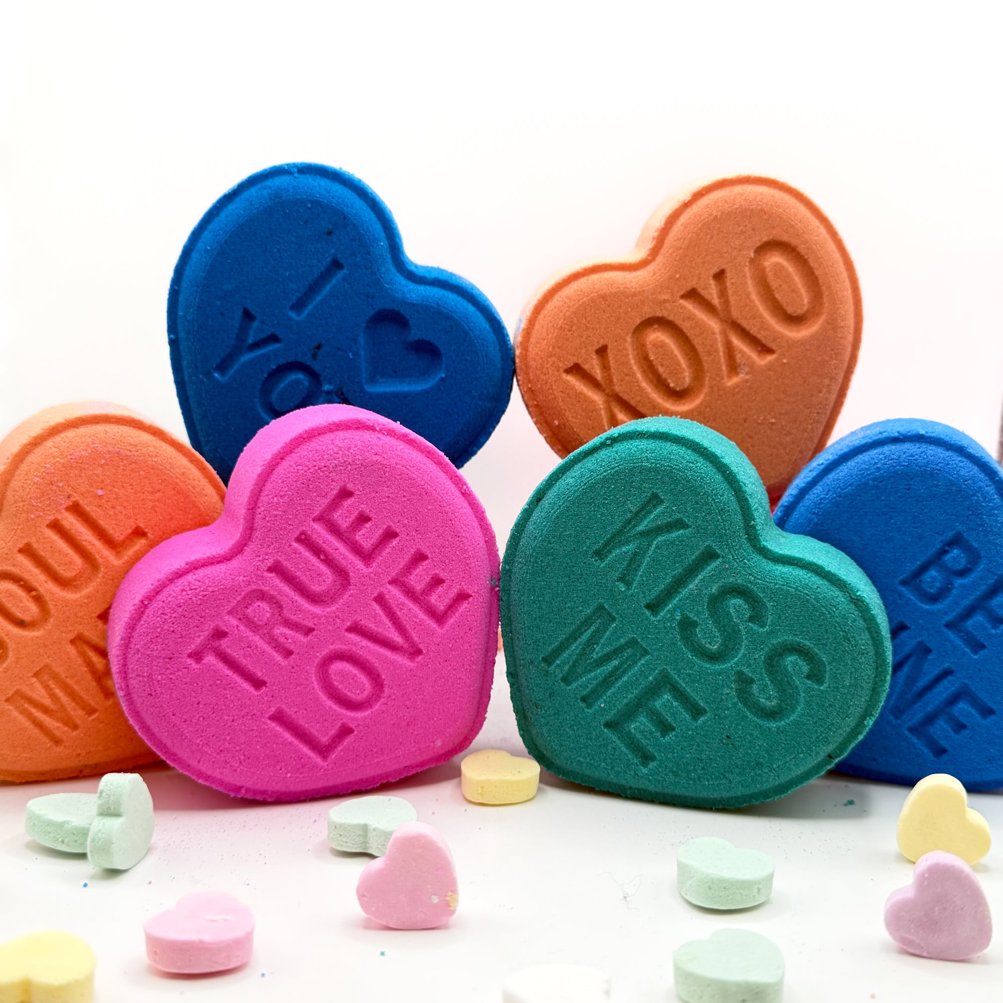 Six conversation heart shaped bath bombs. Colors are the following pastels blue, purple, yellow, green, pink, peach