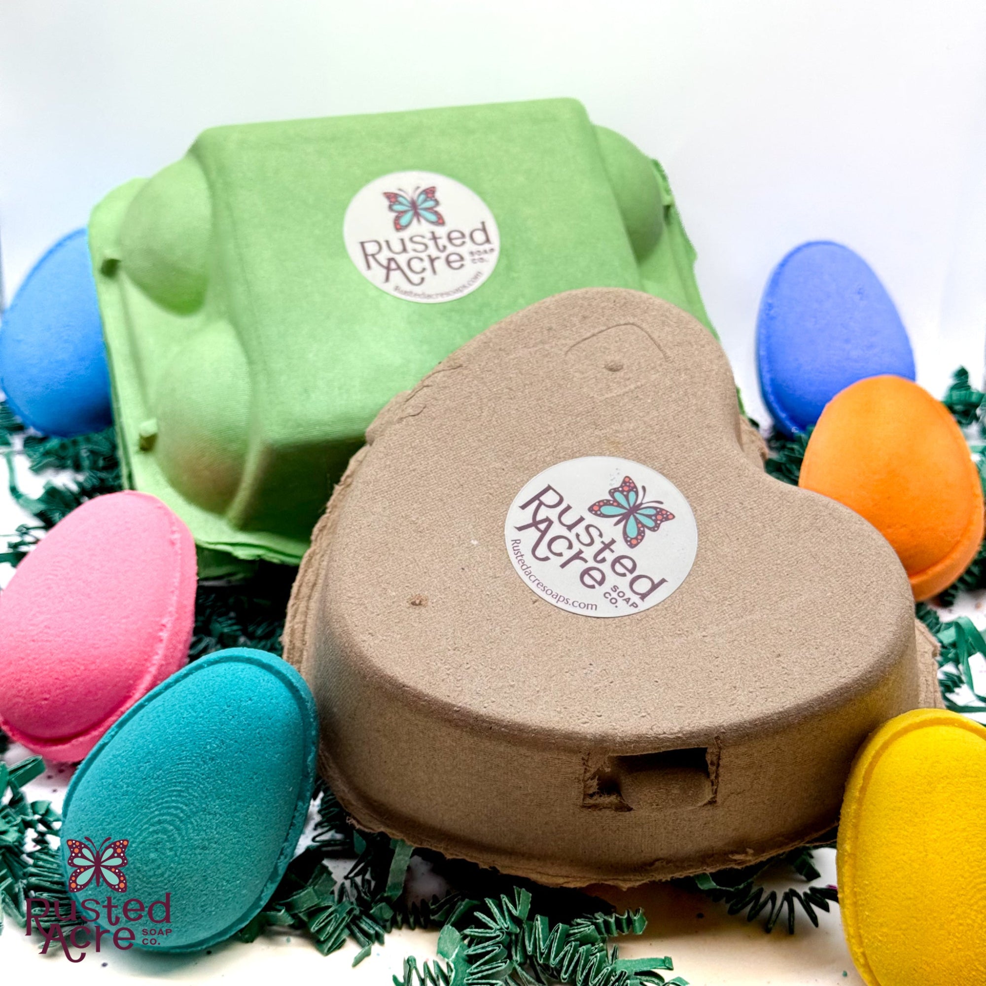 Colorful egg cartons and a heart shaped egg carton with egg shaped bath bombs for easter made by Rusted Acre Soap Company.