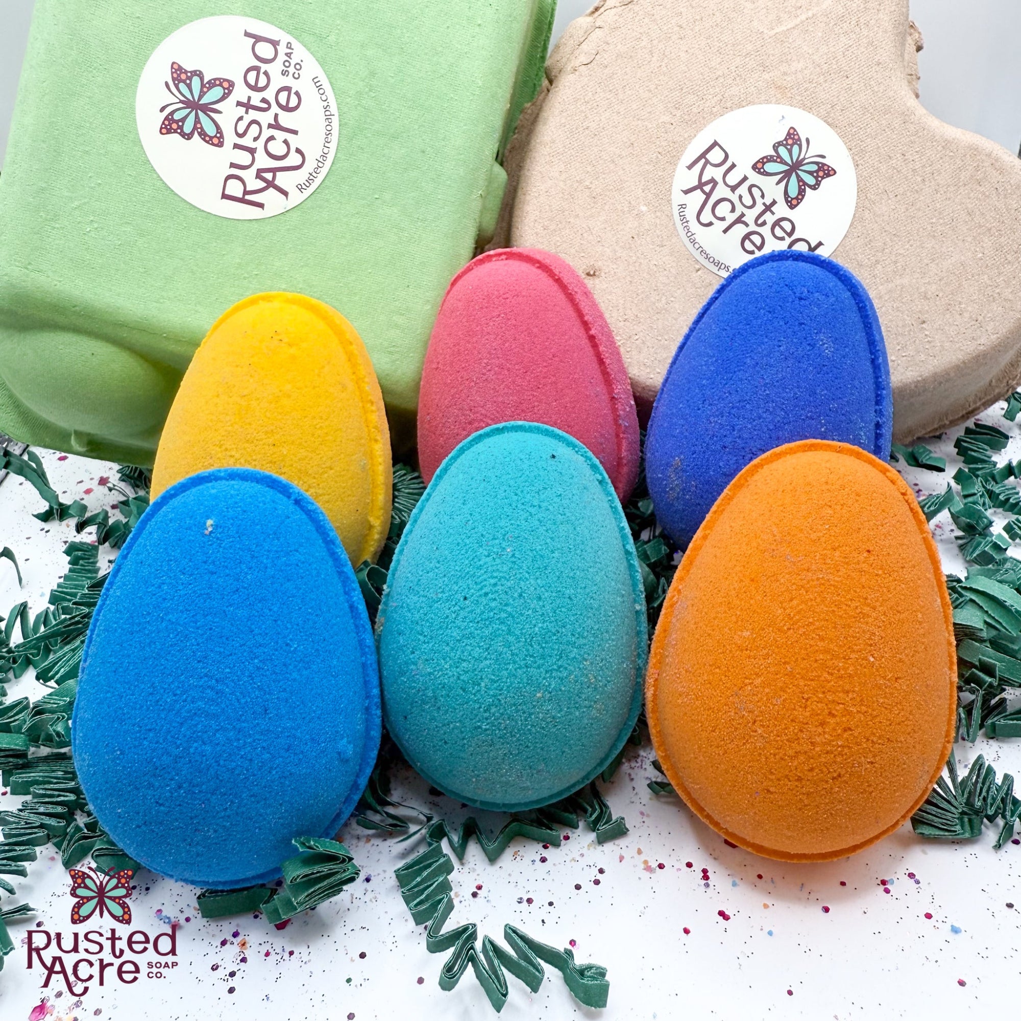 Six colorful egg shaped bath bombs for easter made by Rusted Acre Soap Company.