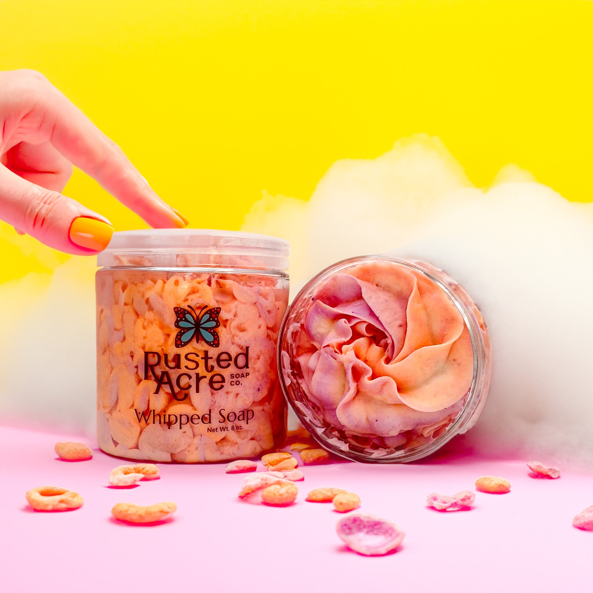 Two jars of Rusted Acre Soap Company’s fruity cereal whipped soap front and top view in a lifestyle setting.