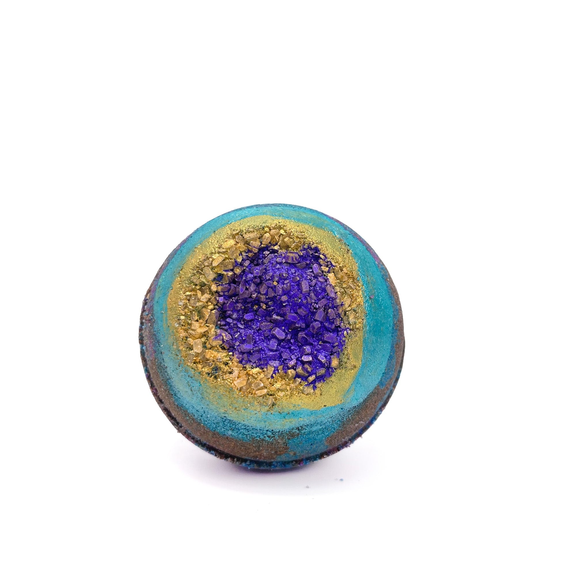 Round bath bomb swirled with black and teal embedded with gold sea salt.