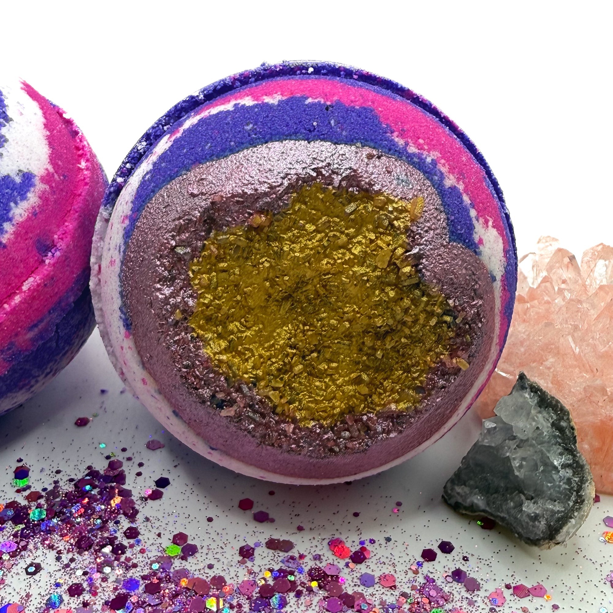 Round bath bomb made of red, white, and blue hand-painted gold and red Epsom salt.