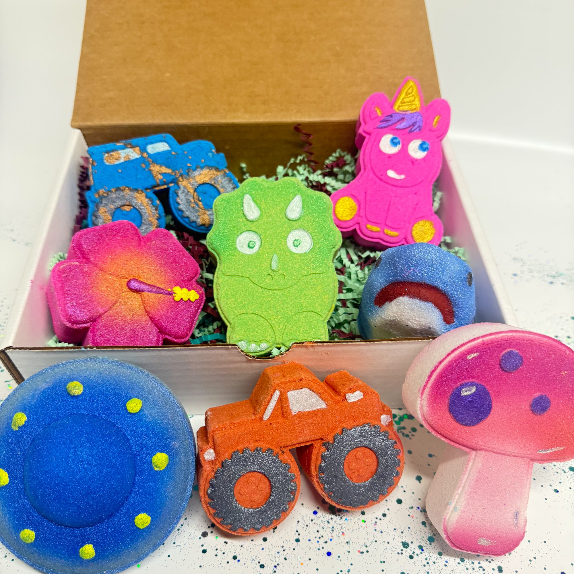 A box full of different kids themed bath bombs in multiple colors for a kids subscription box.