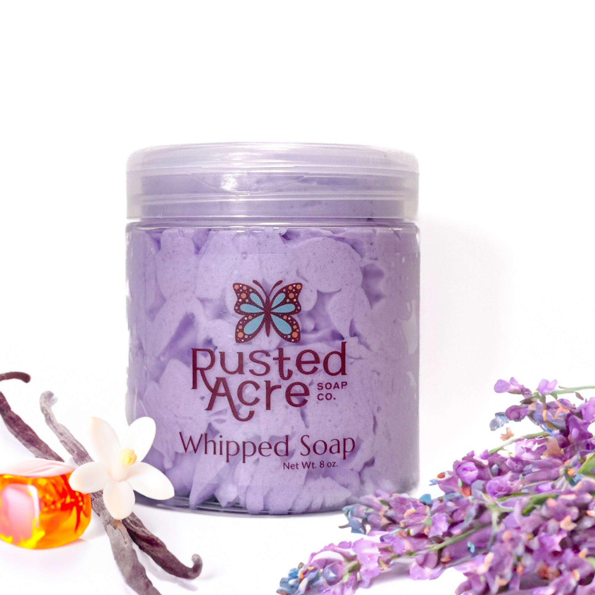 Jar of Rusted Acre Soap Company's vegan Lavender whipped soap. Purple soap in a reusable plastic jar in a lifestyle setting.