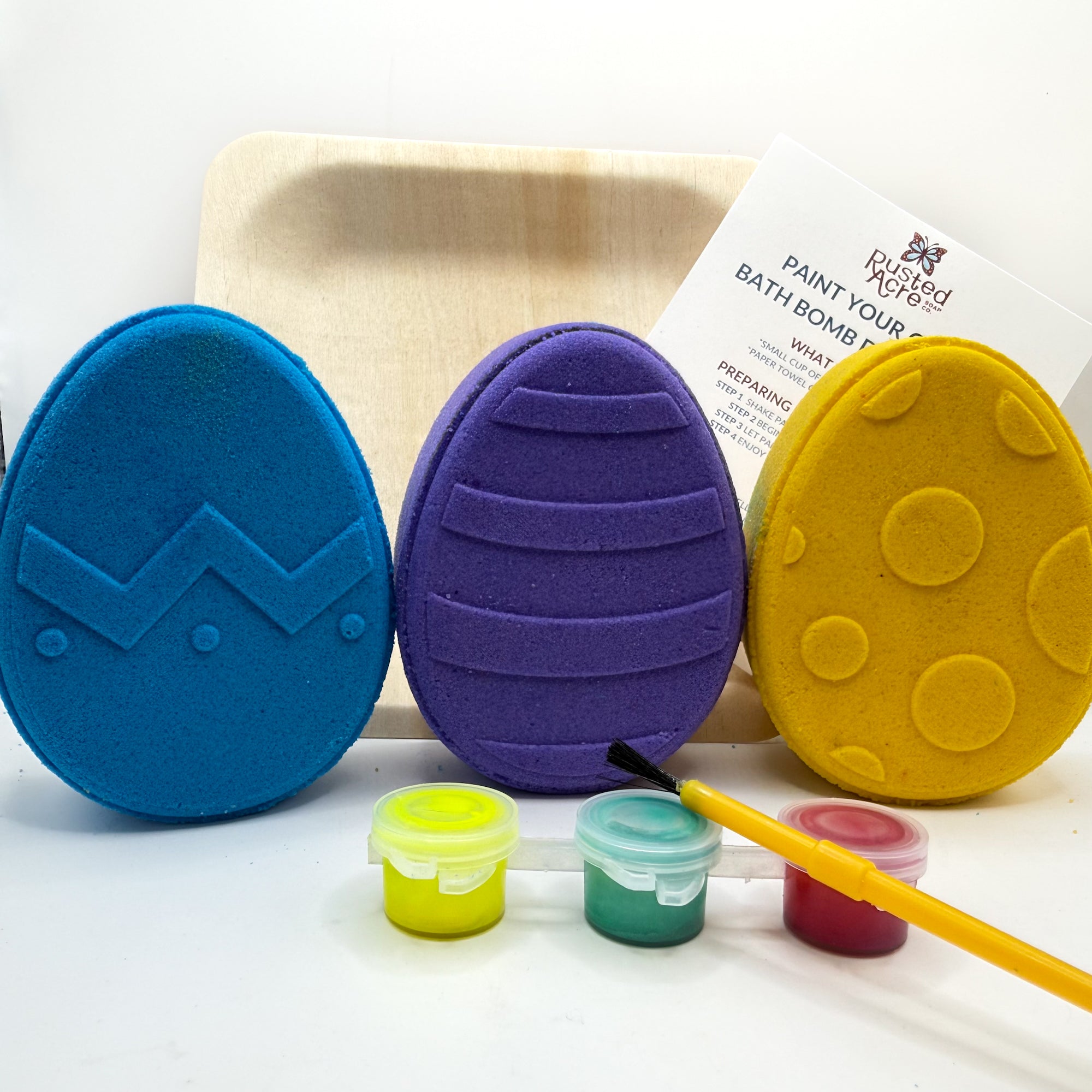 Paint your own easter egg kit with all eggs pictured, white bath bombs and painting supplies. Made by Rusted Acre Soap Co.