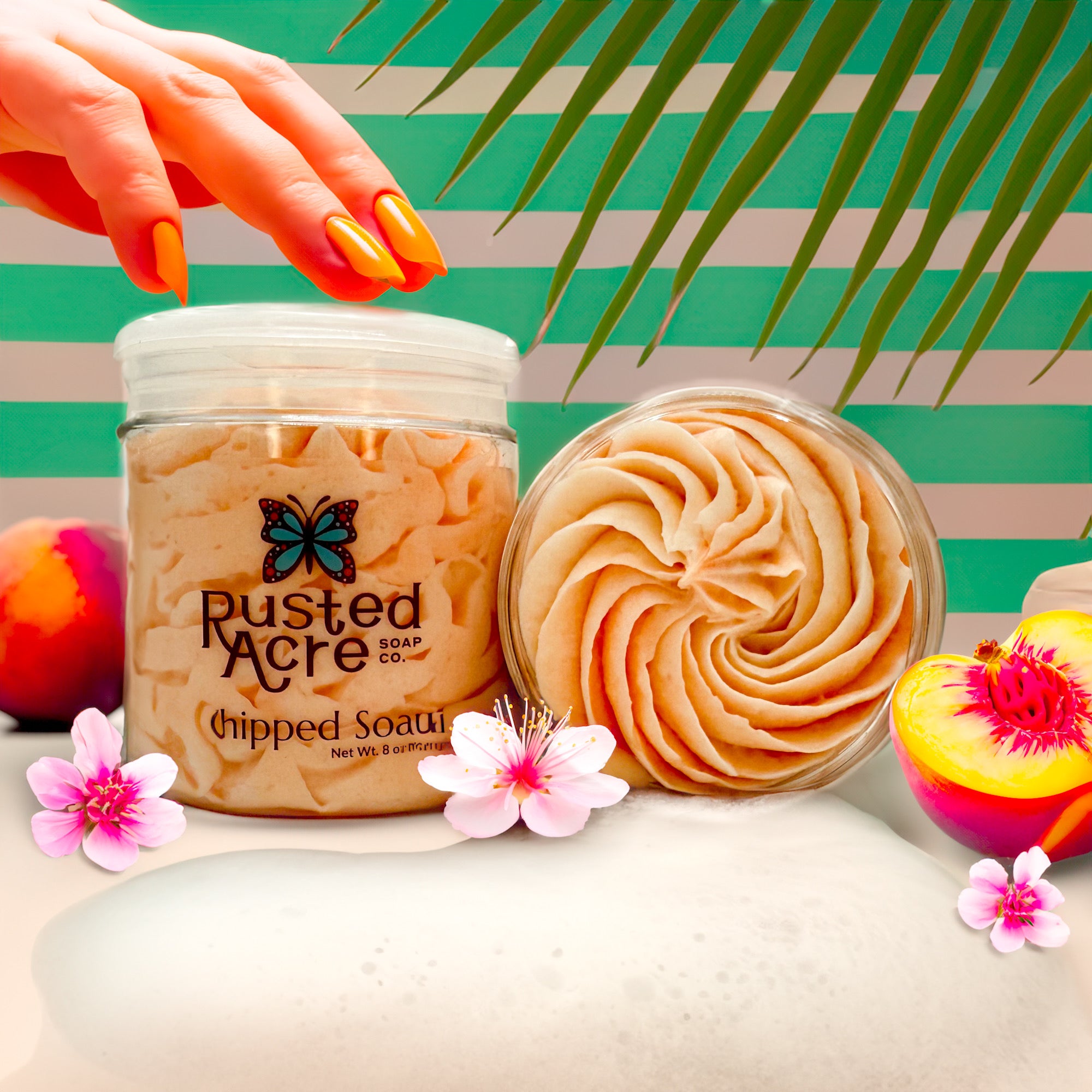 Two jars of Rusted Acre Soap Company’s peach whipped soap front and top view in a lifestyle setting.