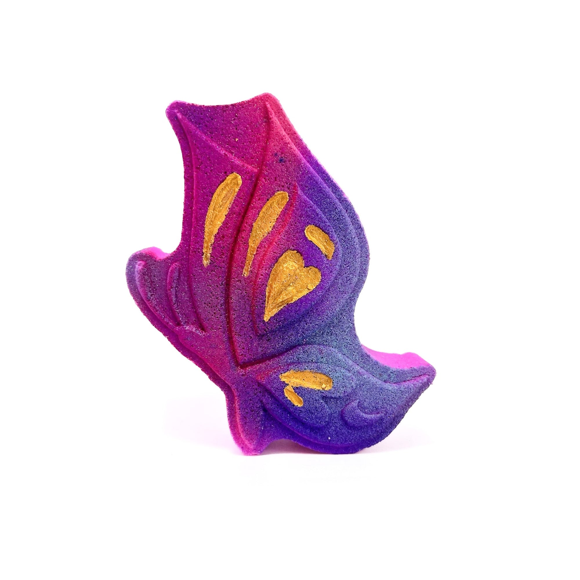 A pink butterfly shaped bath bomb. Hand-painted gold highlights, purple airbrush.