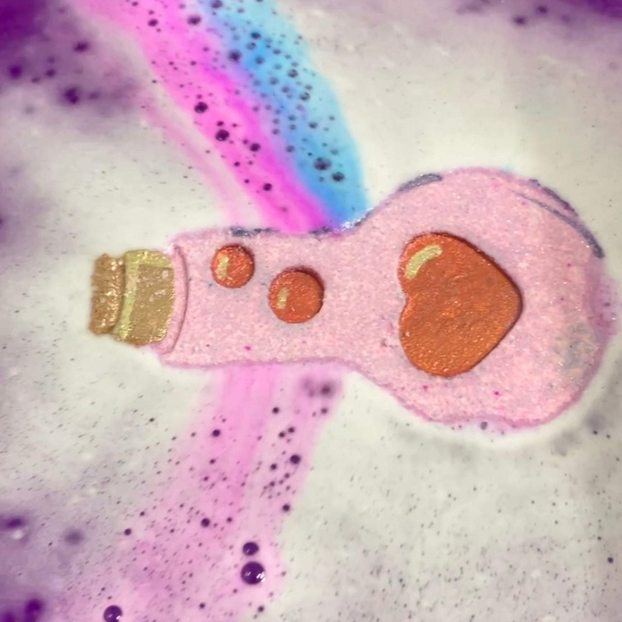 Rusted Acre Soap Companies Love Potion bath bomb putting on a color show.