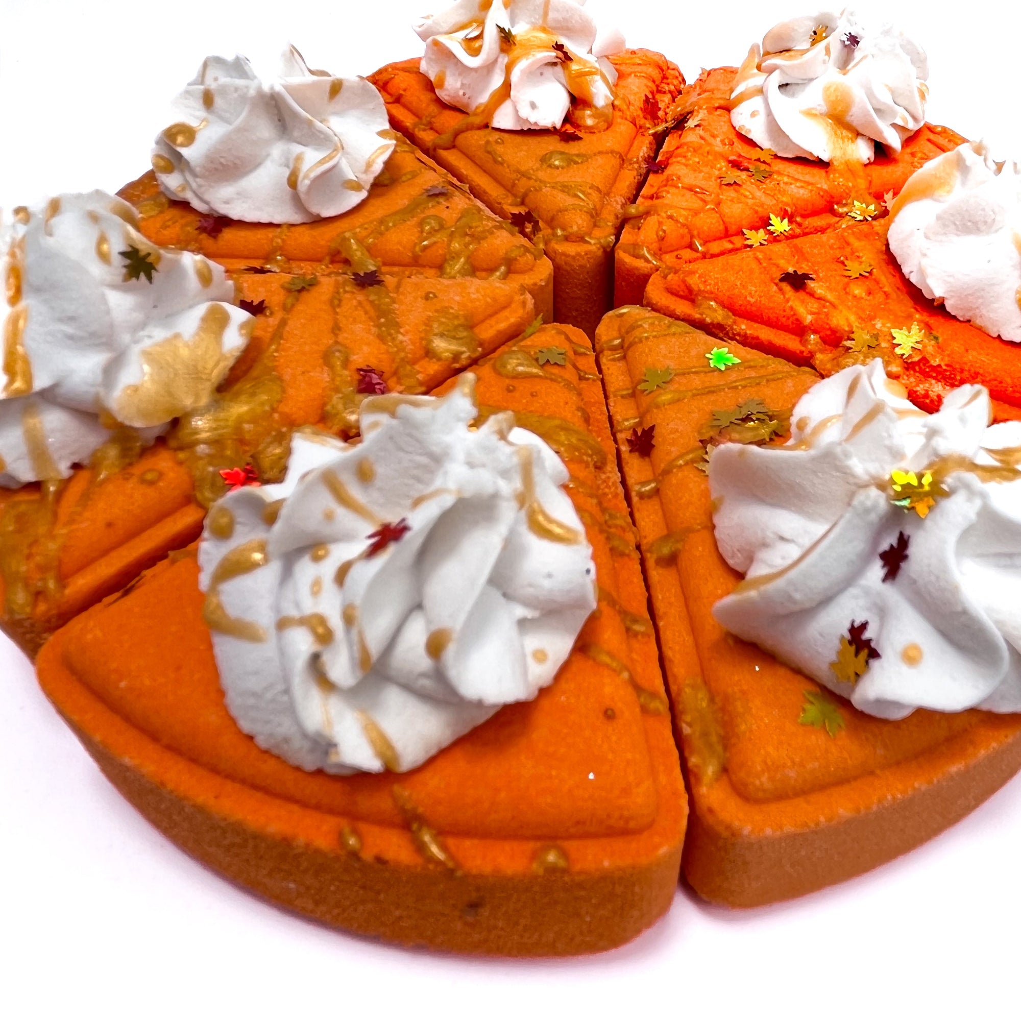 Pumpkin pie bath bombs in a pie shape slice. Handmade by Rusted Acre Soap Co.