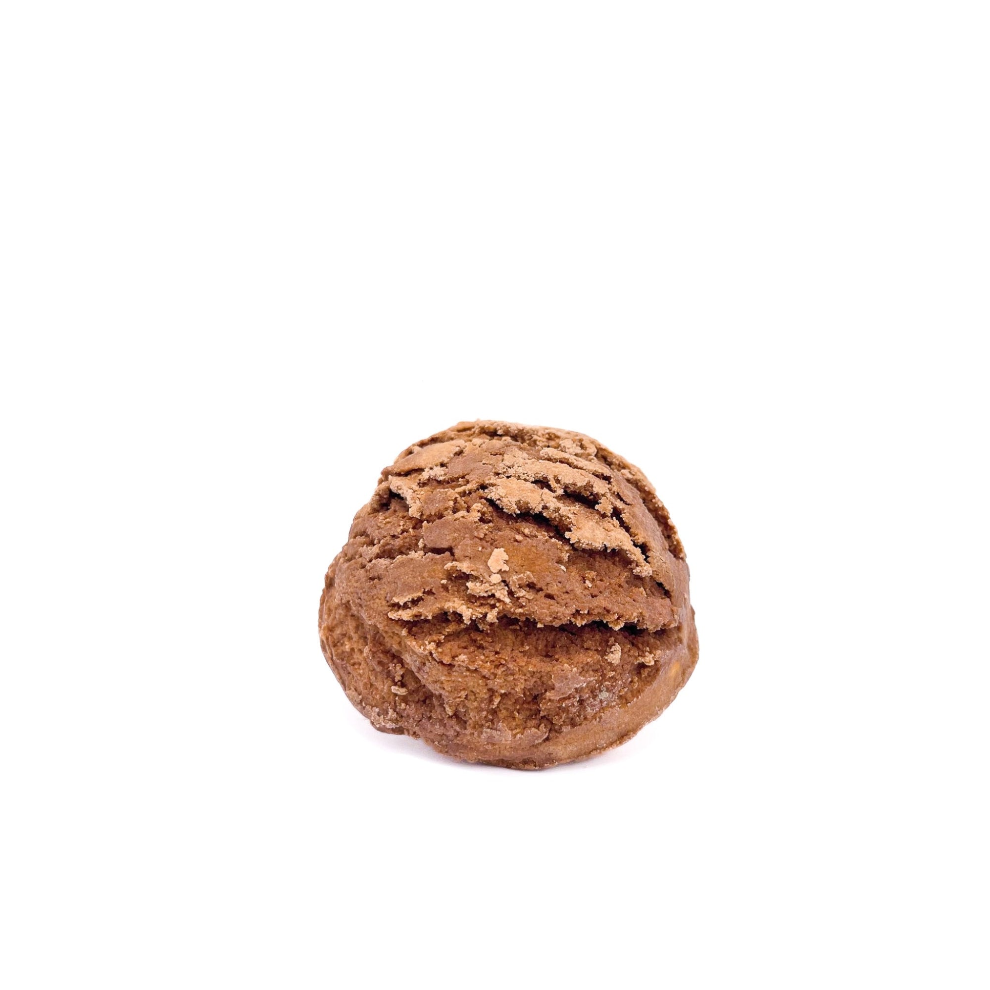 A scoop of deep reddish-orange bubble bar resembling a scoop of ice cream.