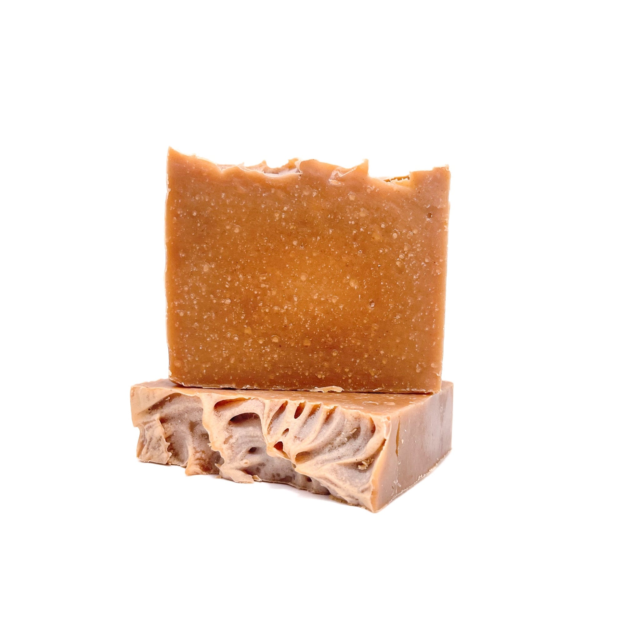 Two bars of pumpkin spice scented handmade bar soap. One showing the top for texture.