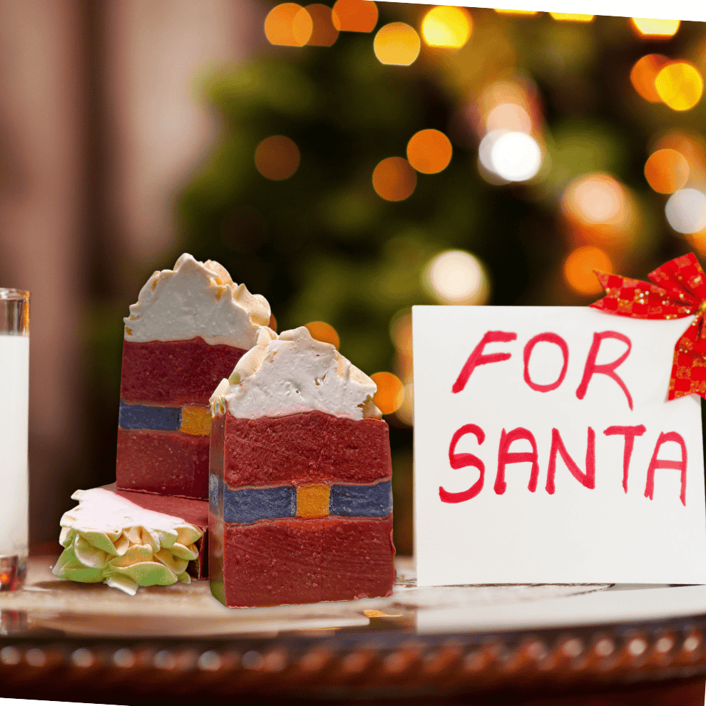 Two bars of Rusted Acre Soap Company's Santa Belt bar soap. Sign saying "FOR SANTA" visible next to them.