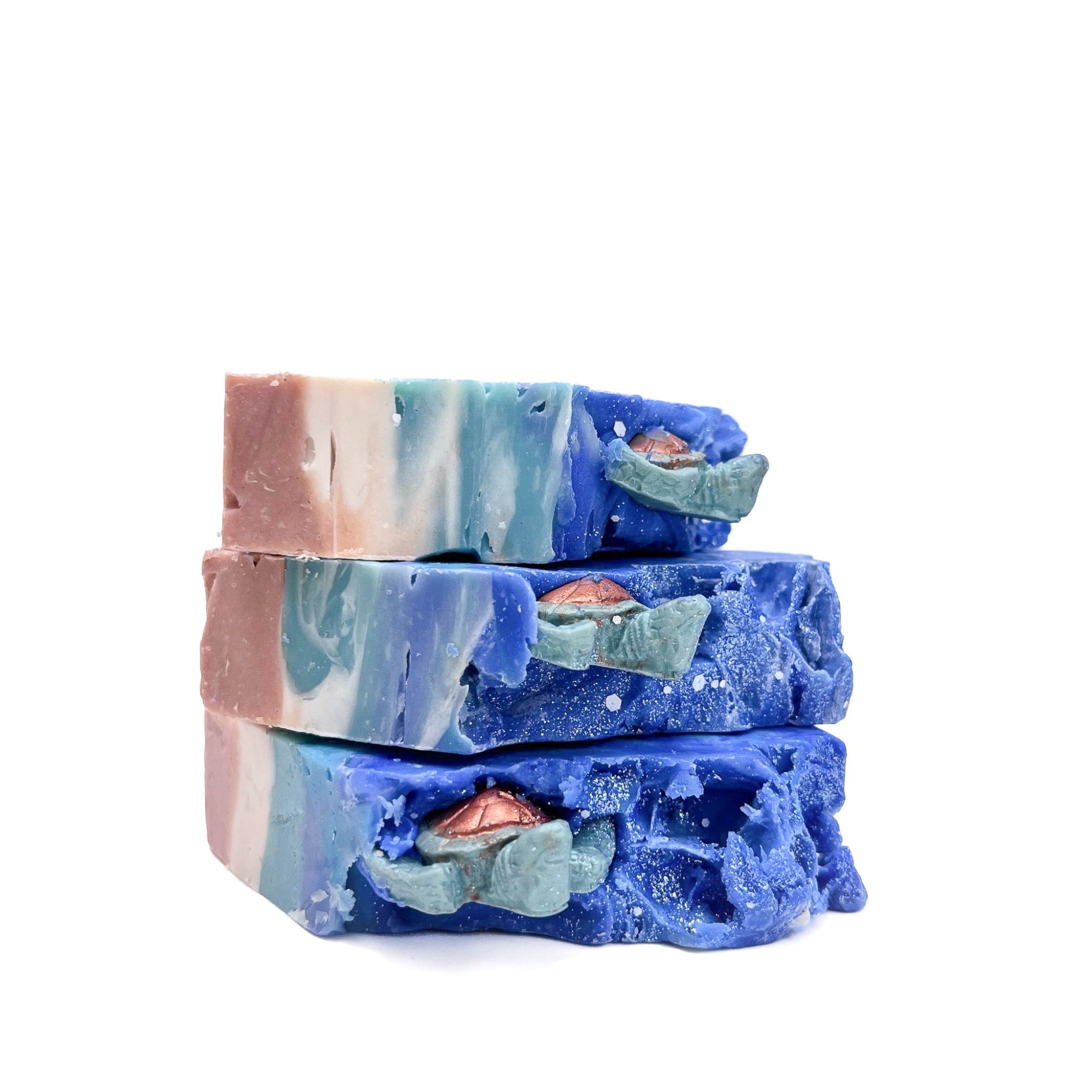 Three bars of Rusted Acre Soap Company's Sea Turtle soap stacked on their sides to show top.