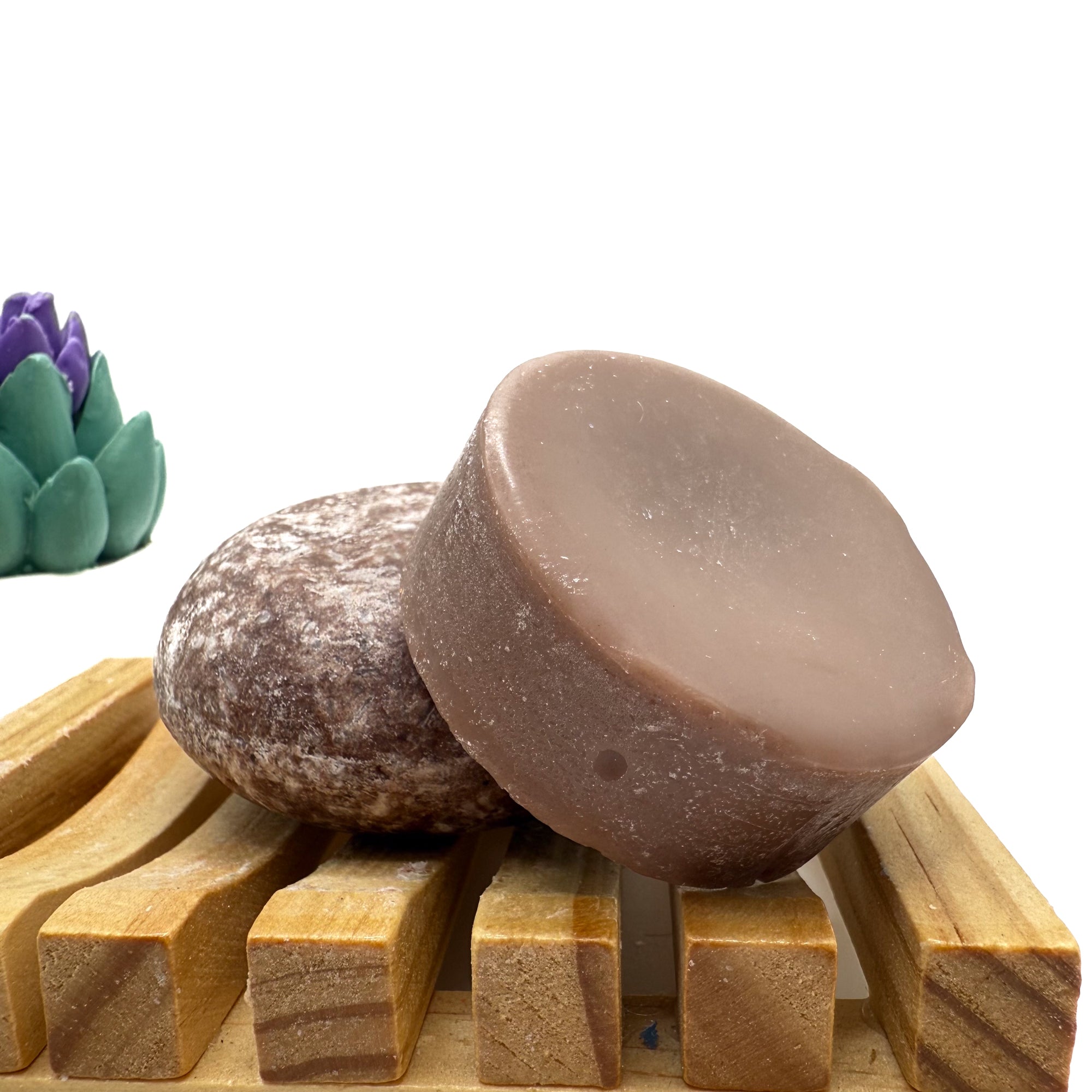 Brown moroccan spice zero waste Shampoo and Conditioner bar on a wood soap dish with a white background.