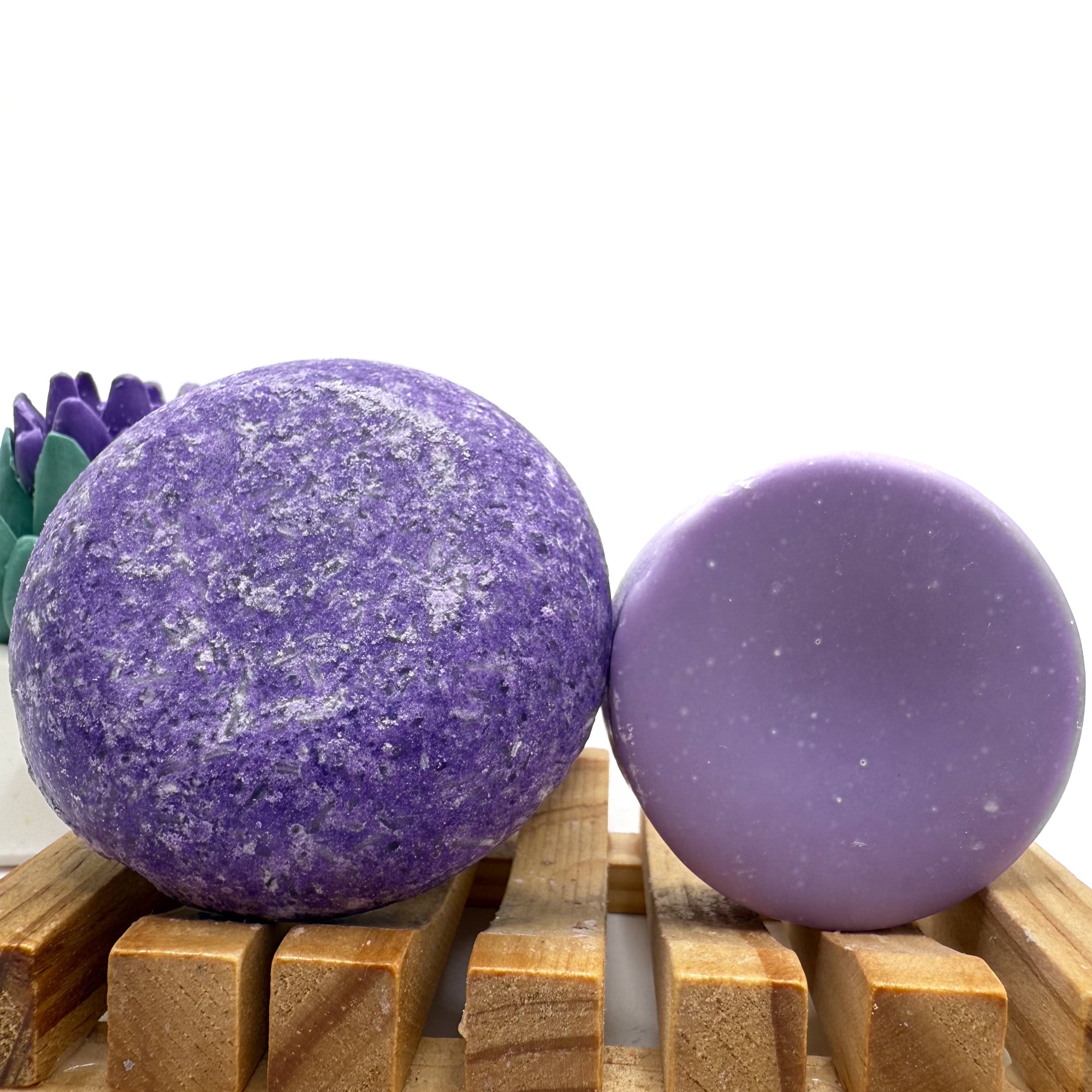 Pomegranate  zero waste Shampoo and Conditioner bar on a wood soap dish with a white background standing on side.