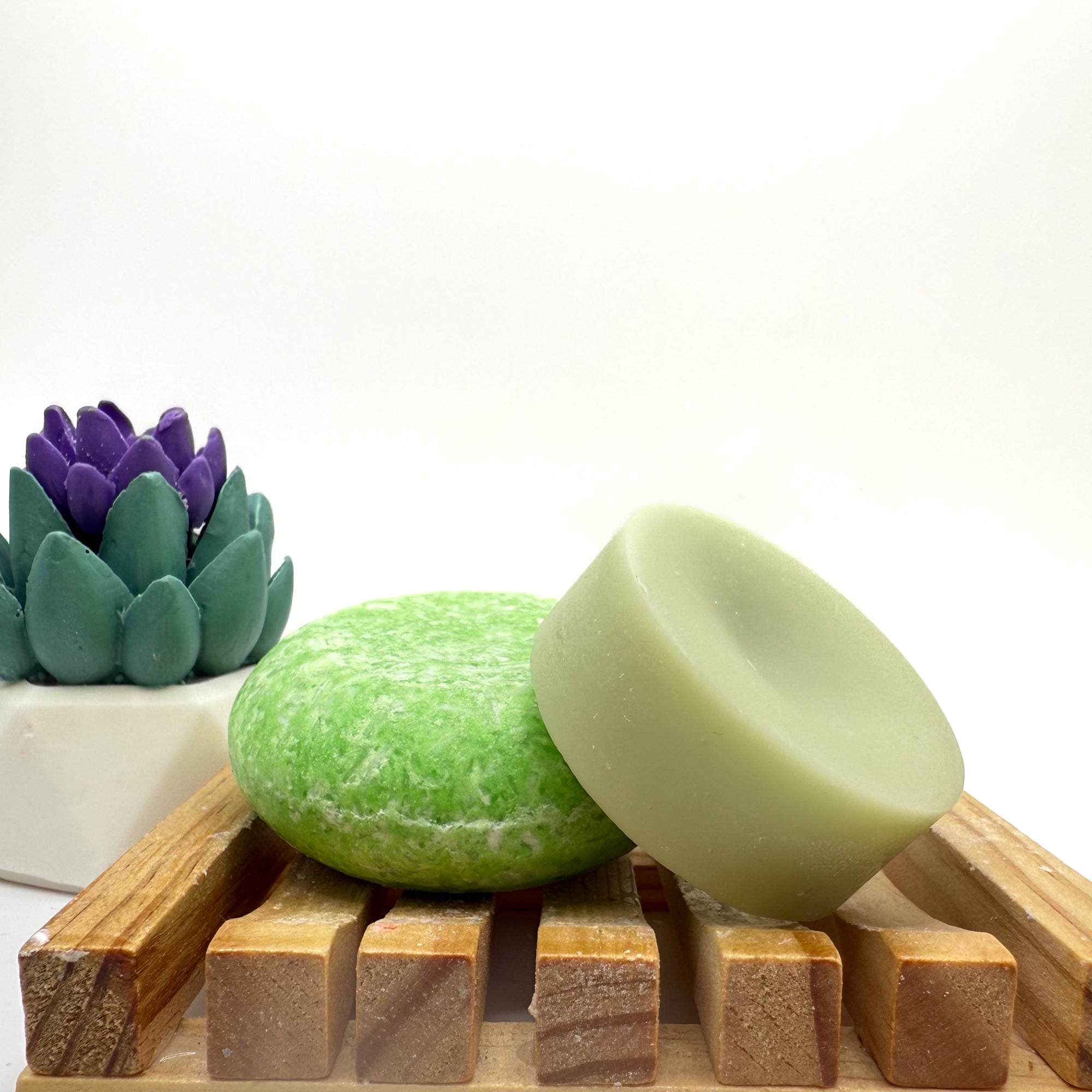 Green Summer Melon zero waste Shampoo and Conditioner bar on a wood soap dish with a white background.