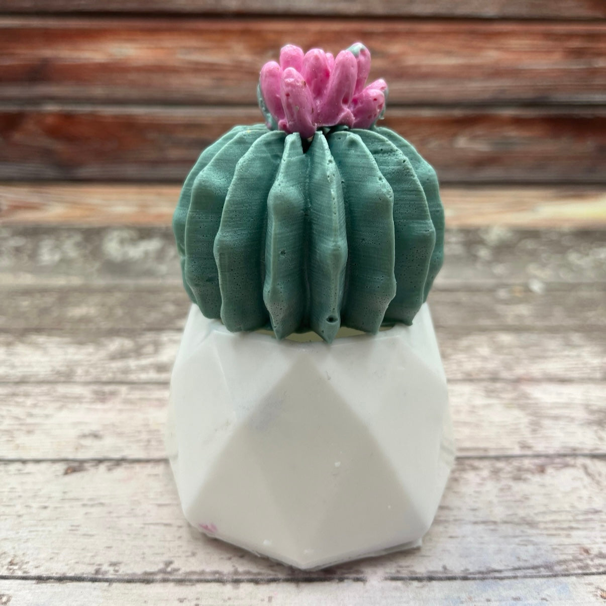 Decorative cactus soap with pink top in a white pot on a wooden surface handmade by Rusted Acre Soap Co.