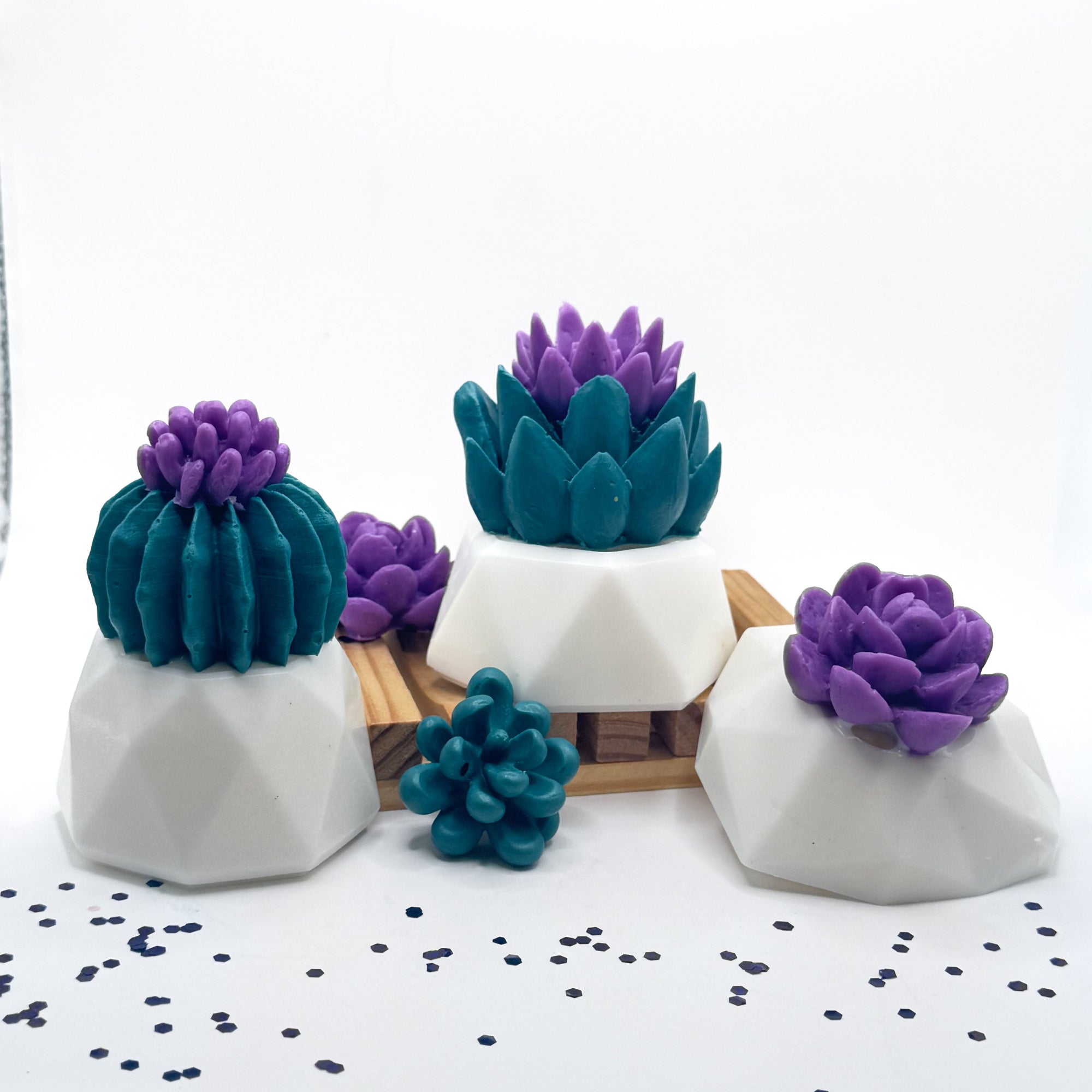 3 decorative succulent soaps with purple flowers and a white flower pot with wooden soap lift handmade by Rusted Acre Soap Co.