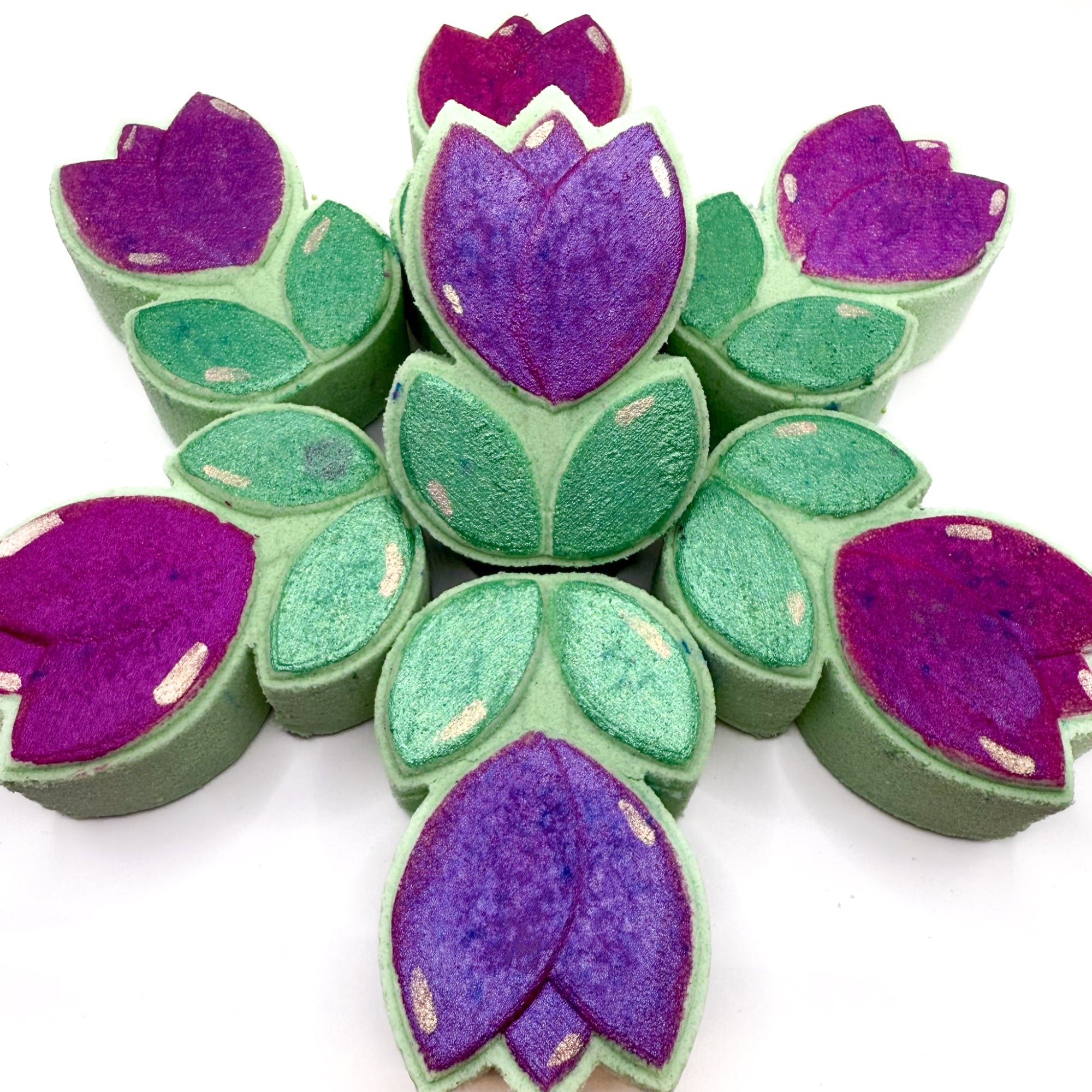 Spring Tulip bath bombs, hand painted and made by Rusted Acre Soap Co. Green and pink/purple hand painted tulip bath bombs arranged in a circle to create a flower look.