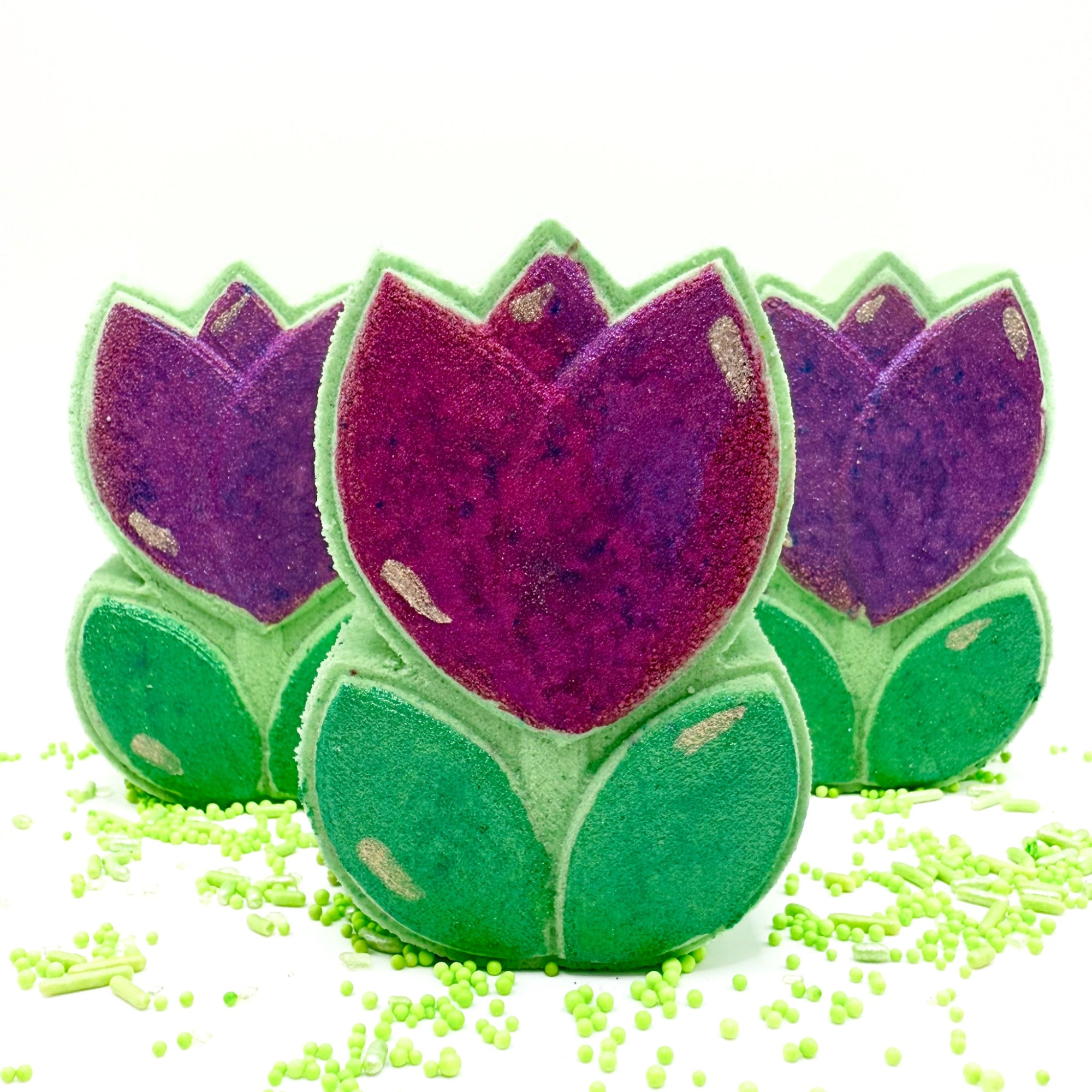 Three Spring Tulip bath bombs, hand painted and made by Rusted Acre Soap Co. Green and pink/purple hand painted tulip bath bomb 3 standing up for multi view.