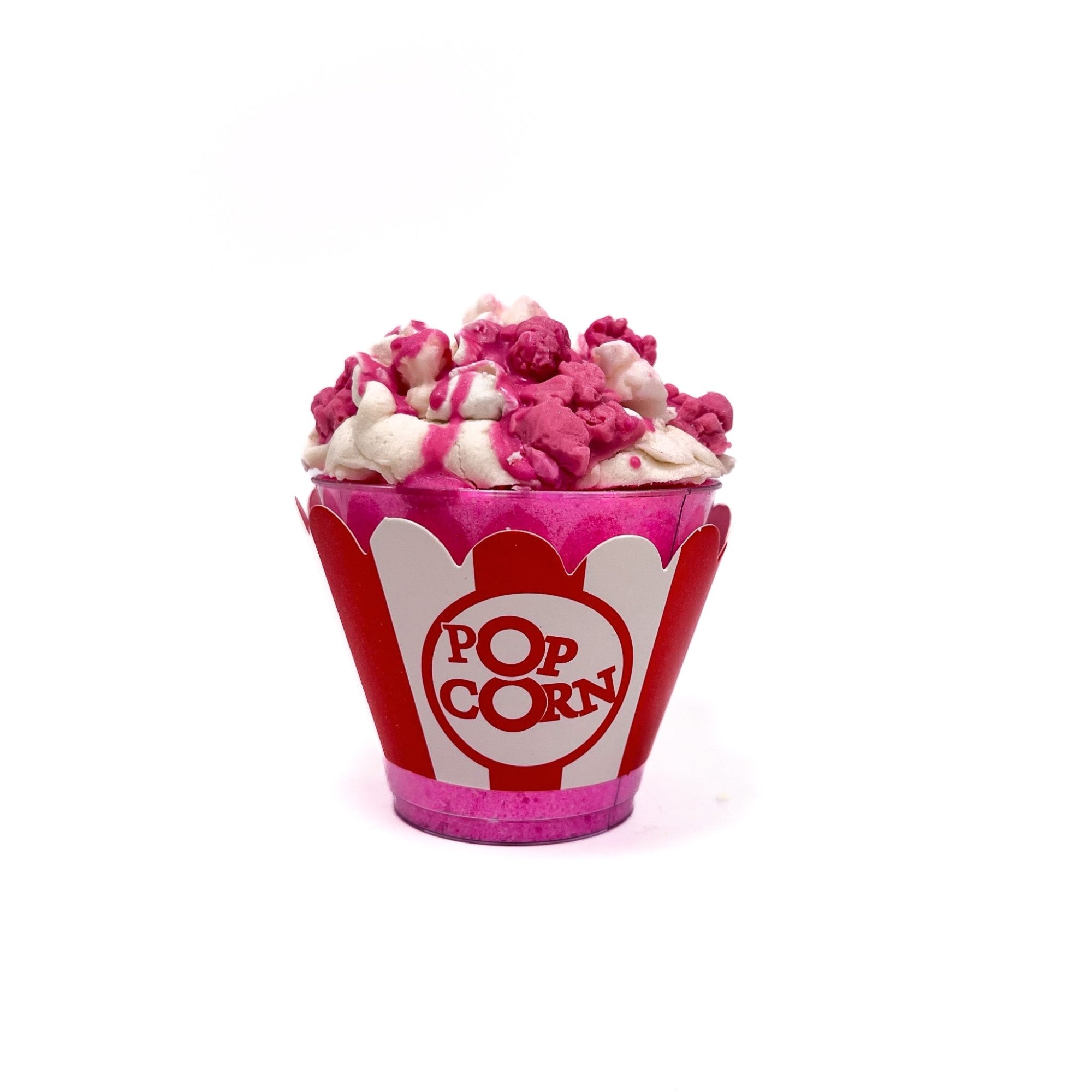 One clear bucket of pink bath bomb mix with pink and white soap embed on top. Wrapper wit POPCORN" visible.