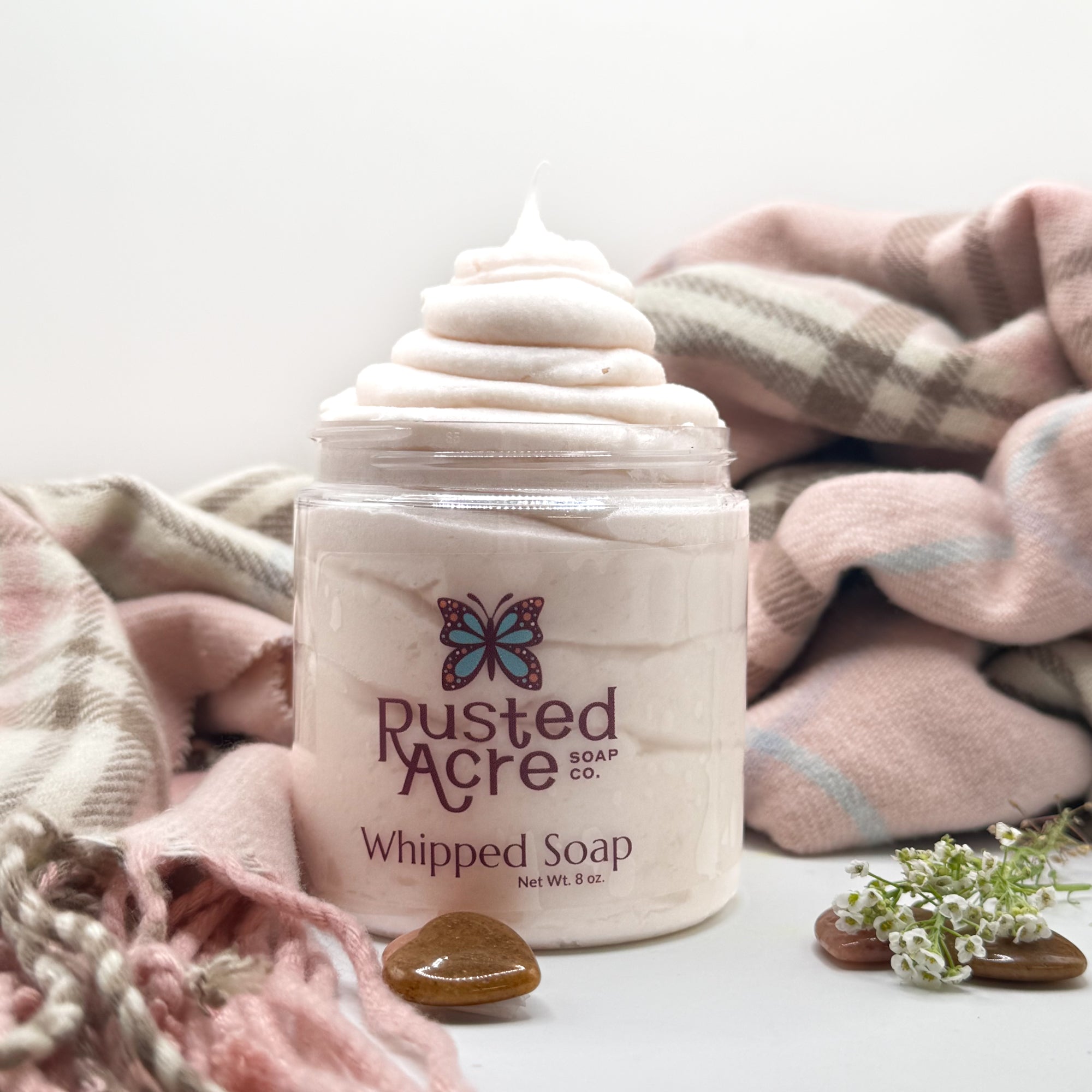 One jar of Rusted Acre Soap CO’s cashmere whipped soap on a white background with photo props.