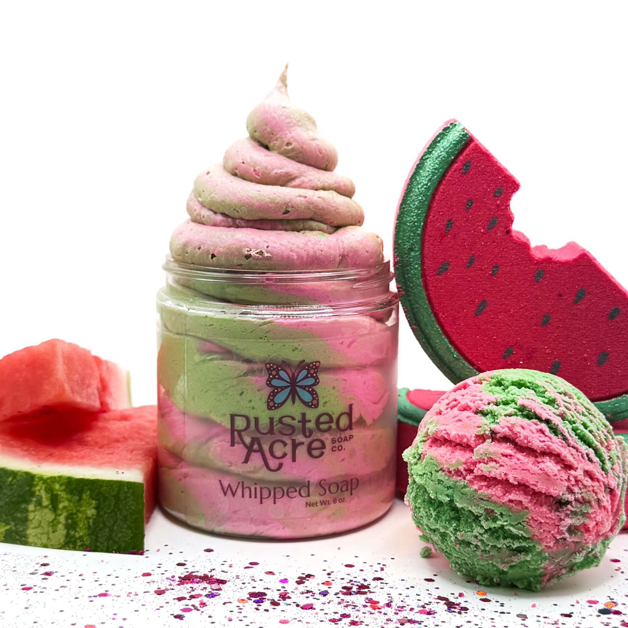 Jar of Rusted Acre watermelon twist whipped soap with watermelon themed items on a white background