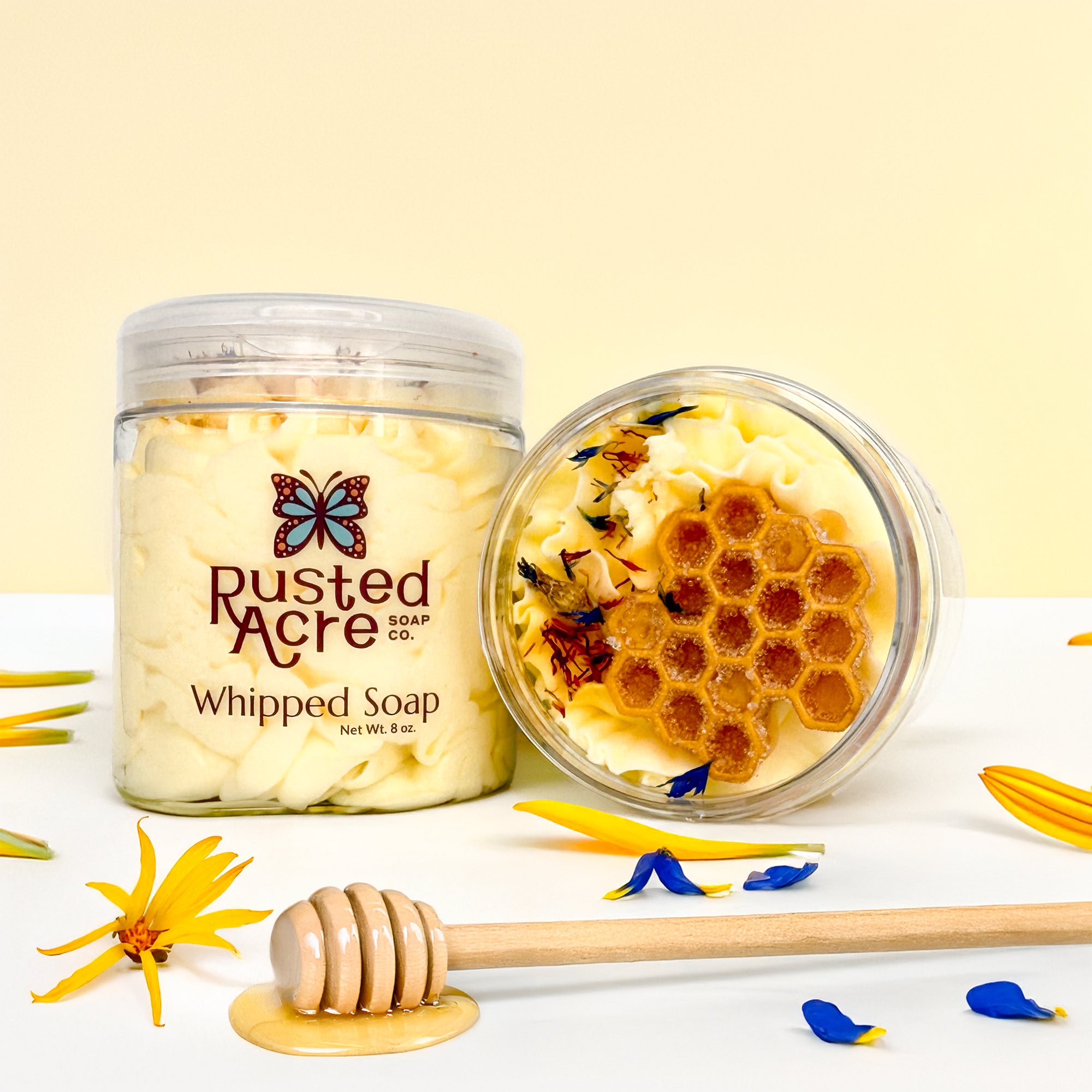 Two jars of Rusted Acre Soap Company's wildflower honey whipped soap in a lifestyle image.