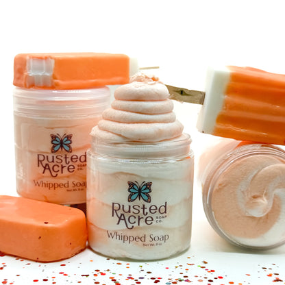 3 jars of orange and white swirl whipped soap with ice cream bars by Rusted Acre Soap Co.