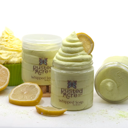 3 jars of Rusted Acre lemon cupcake whipped soap with lemon slices and cupcake on a white background.