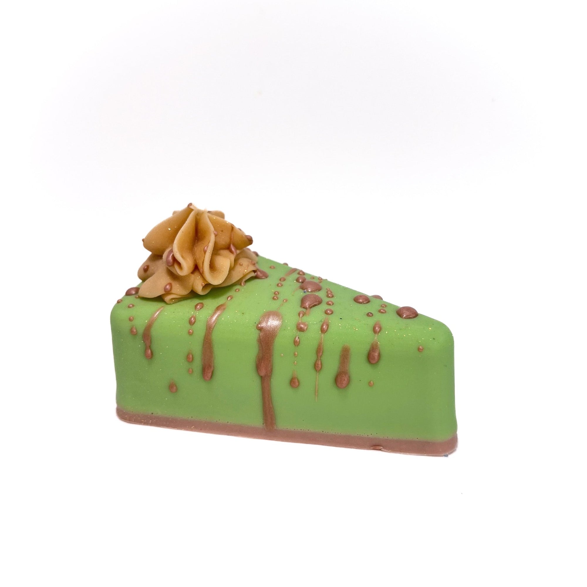 A pie slice shaped soap. Apple green filler, tan crust, topped with a puff of cream colored soap.