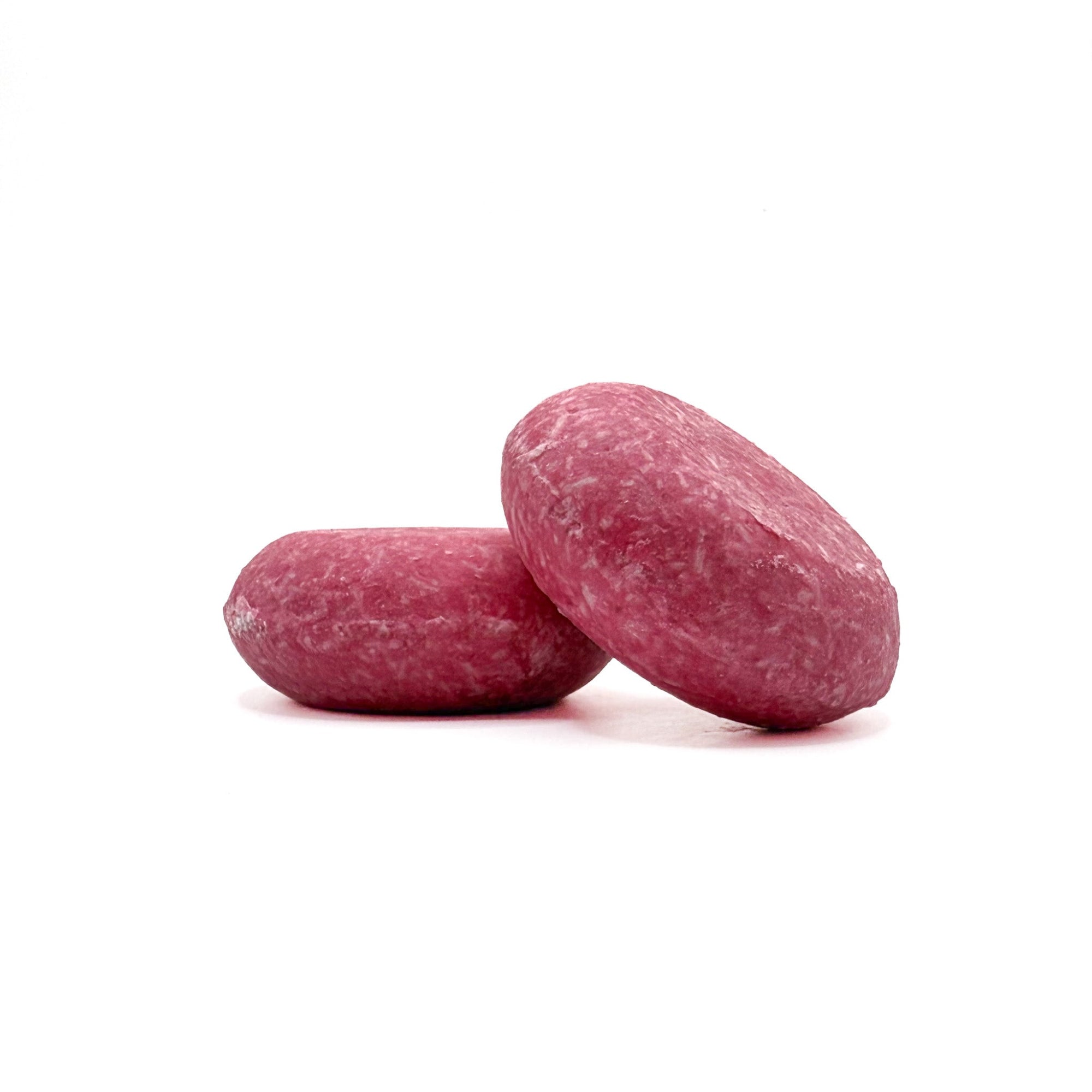 Two pink eco-friendly shampoo bars in beach vibes scent from Rusted Acre Soap Company.