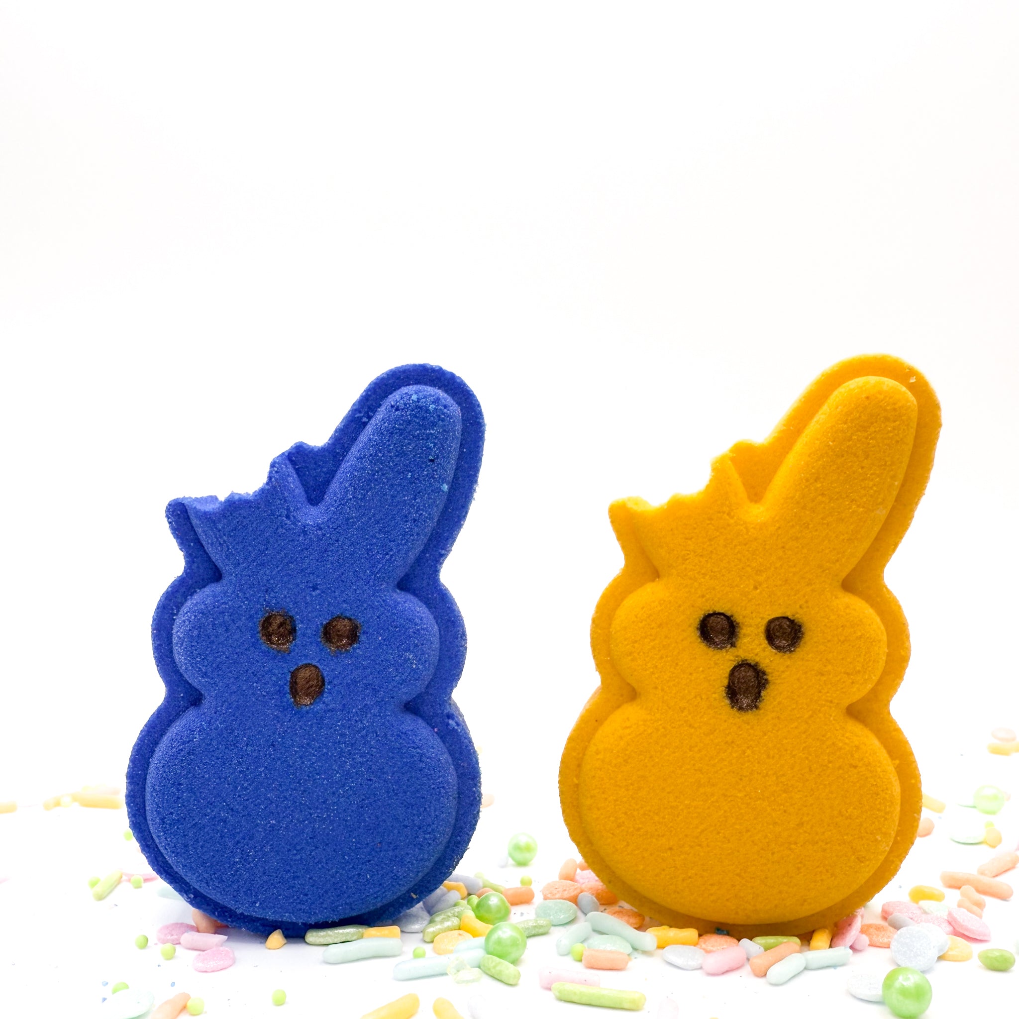 One blue and one purple bitten bunny bath bomb handmade by Rusted Acre Soap Co.