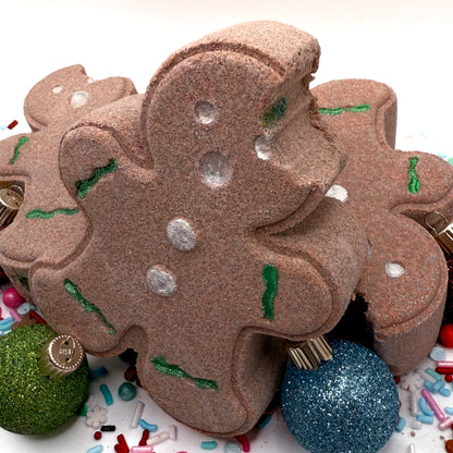 Gingerbread shaped bath bomb with decorative elements on a white background