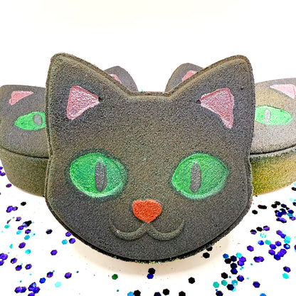 Front-facing Rusted Acre Soap Co. Black Cat Bath Bomb surrounded by more cat-shaped Halloween bath bombs, a fun handmade gift for spooky season.