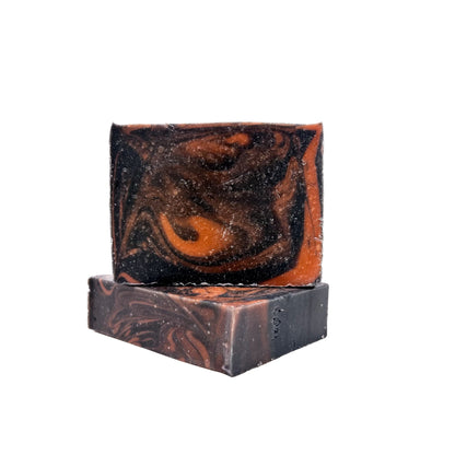 Two bars of black cherry handmade soap swirled red and black.
