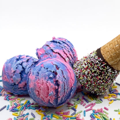 Three pink and purple raspberry vanilla scented bubble bath scoops that look like scoops of ice cream on a white background with sprinkles and an ice cream cone 