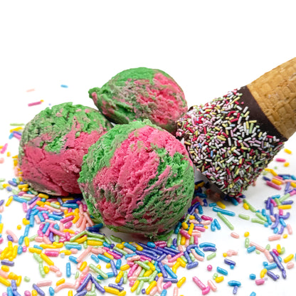Three pink and green ice cream scoop shaped watermelon bubble bath in a waffle cone prop with colorful sprinkles on a white background.
