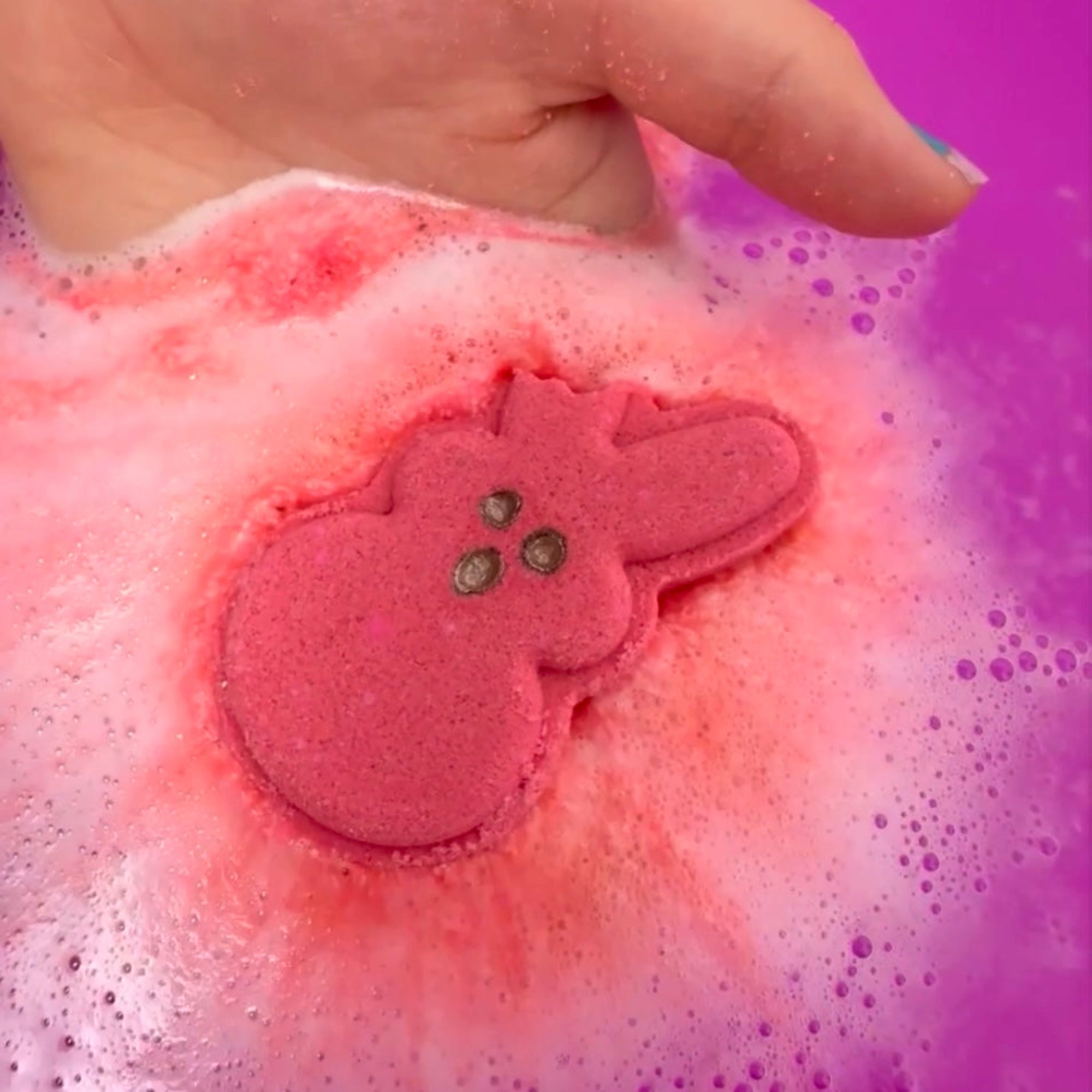 Rusted Acre Soap Companies Biytten Bunny bath bomb putting on a color show.