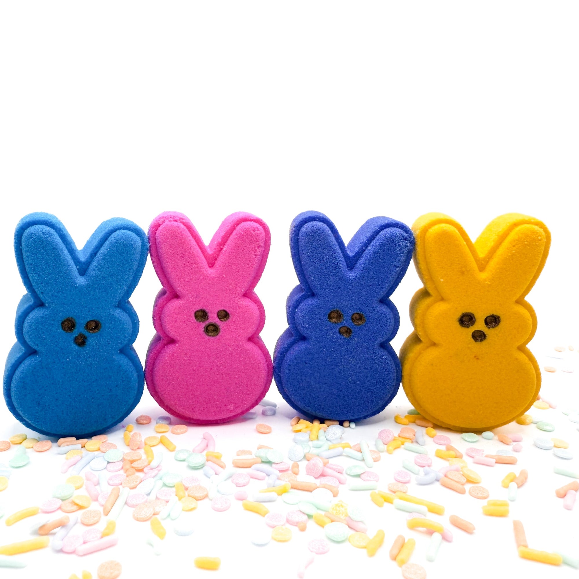 Four Bunny bath bombs handmade by Rusted Acre Soap Co. Colors are, one purple, one blue, one yellow, one pink.