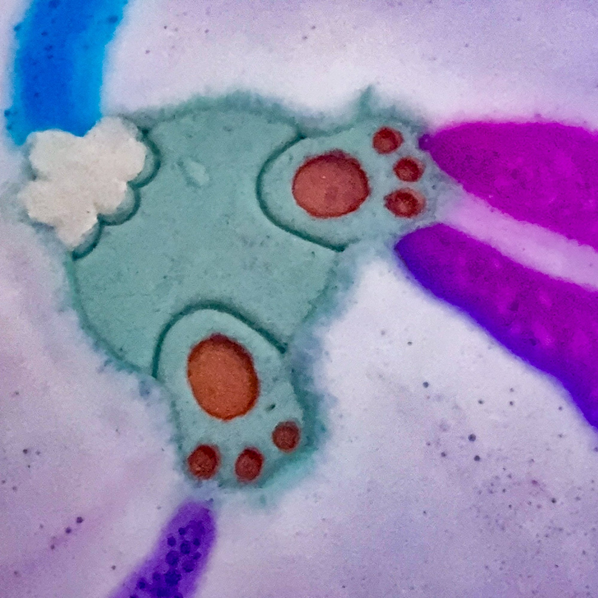 Rusted Acre Soap Companies Bunny Butt bath bomb in the water with a color show. 